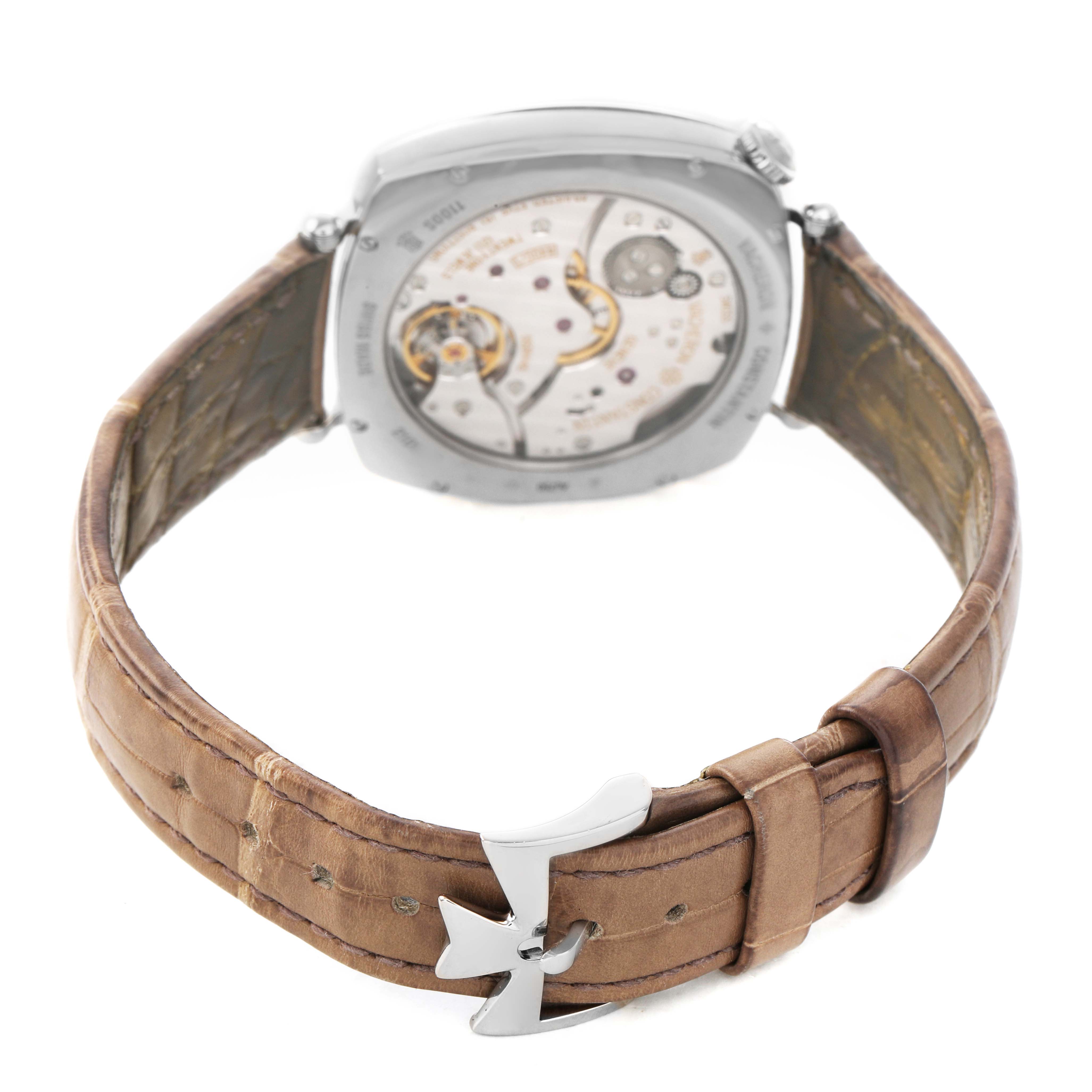 The Vacheron Constantin Historiques 1100S Men's White Gold Silver Dial watch is shown from the rear, highlighting the movement and brown leather strap with a distinctive clasp.