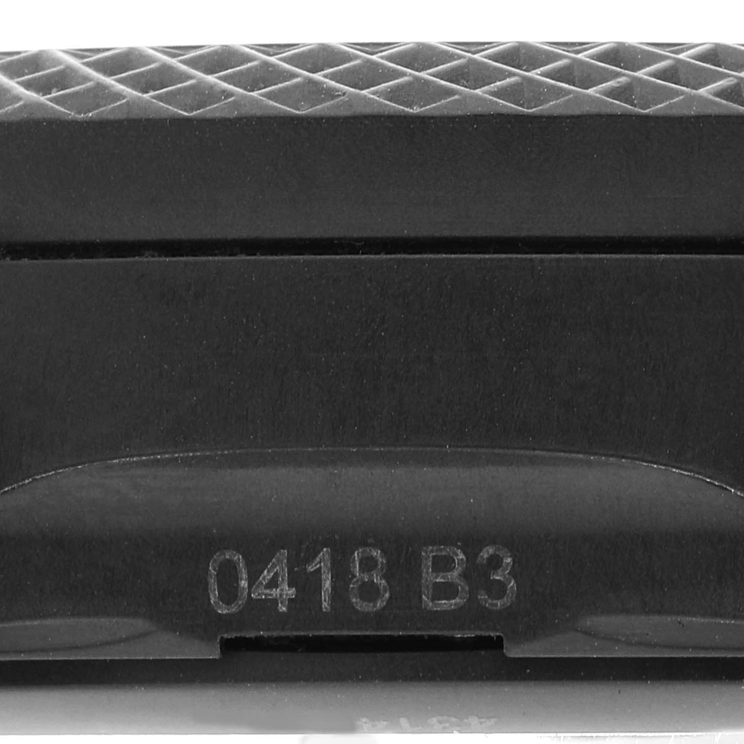 This image depicts a close-up view of the bezel or case side of a Bentley model watch by Breitling, showing a serial number.