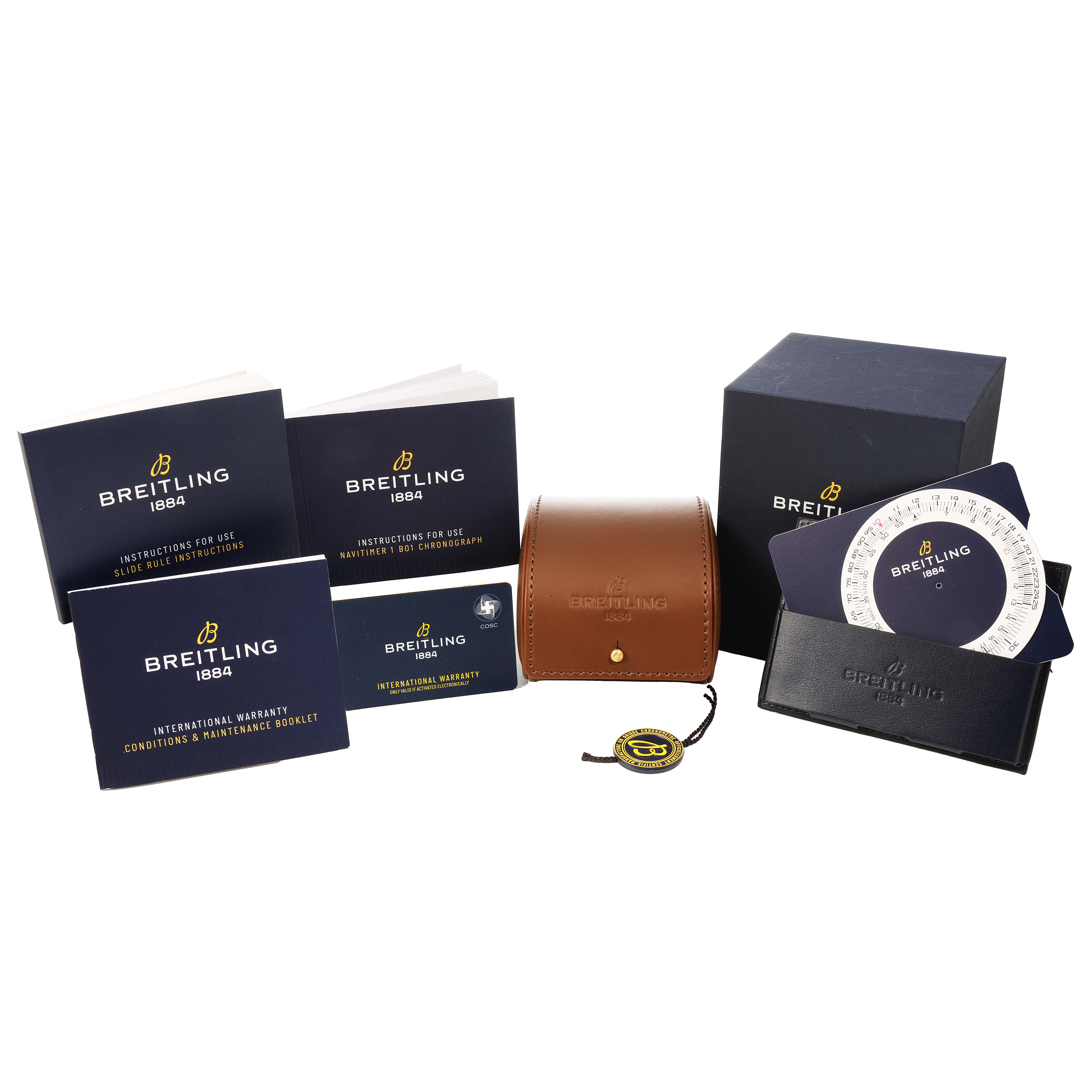 The image shows accessories for a Breitling Navitimer AB0127 Men's Stainless Steel Black Dial, including booklets, a leather pouch, a box, and a circular slide rule tool.
