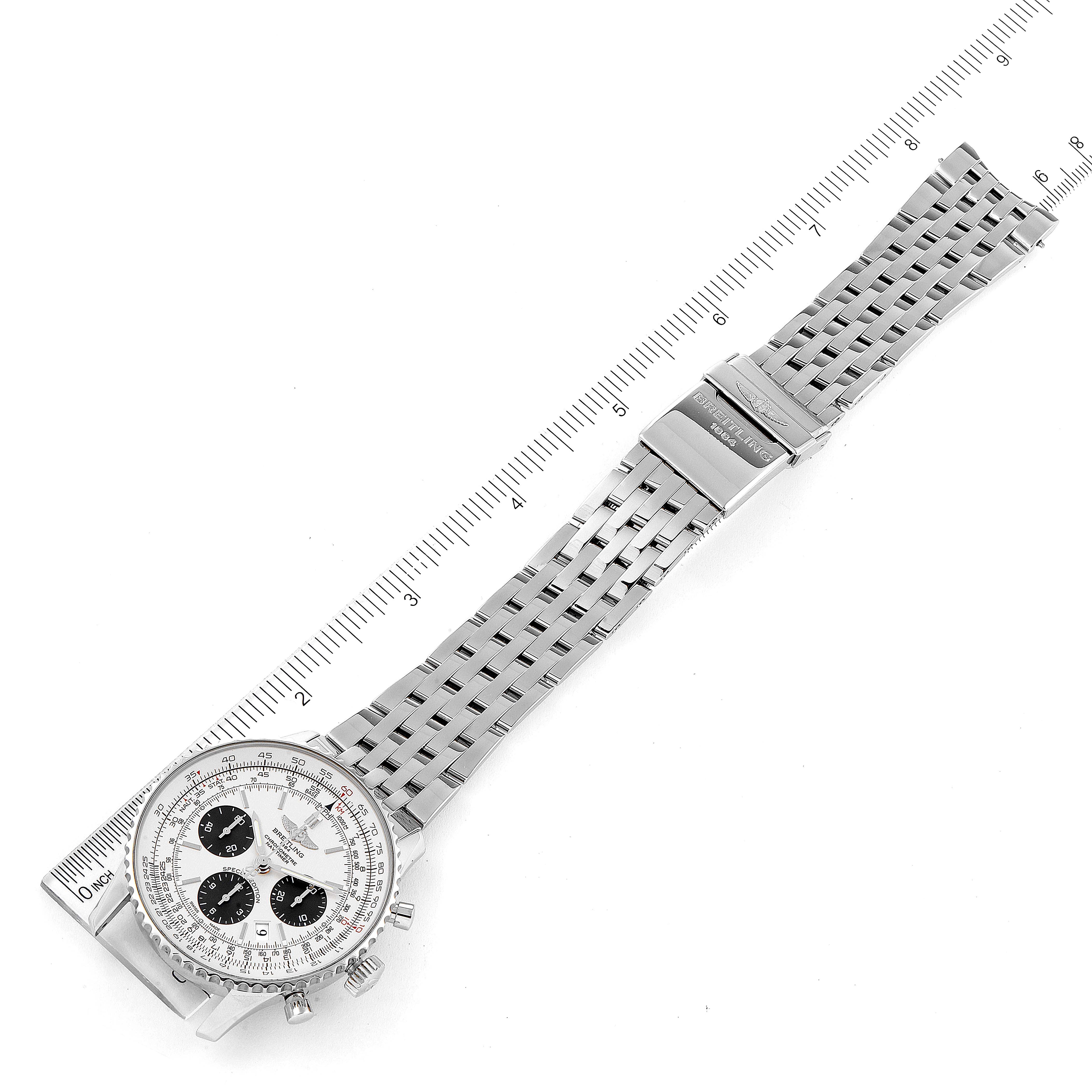 The image shows a top view of the Breitling Navitimer AB0120 Men's Stainless Steel Silver Dial AB0120 Men's Stainless Steel Silver Dial watch, displaying its face, bezel, and metal bracelet with a ruler for scale.