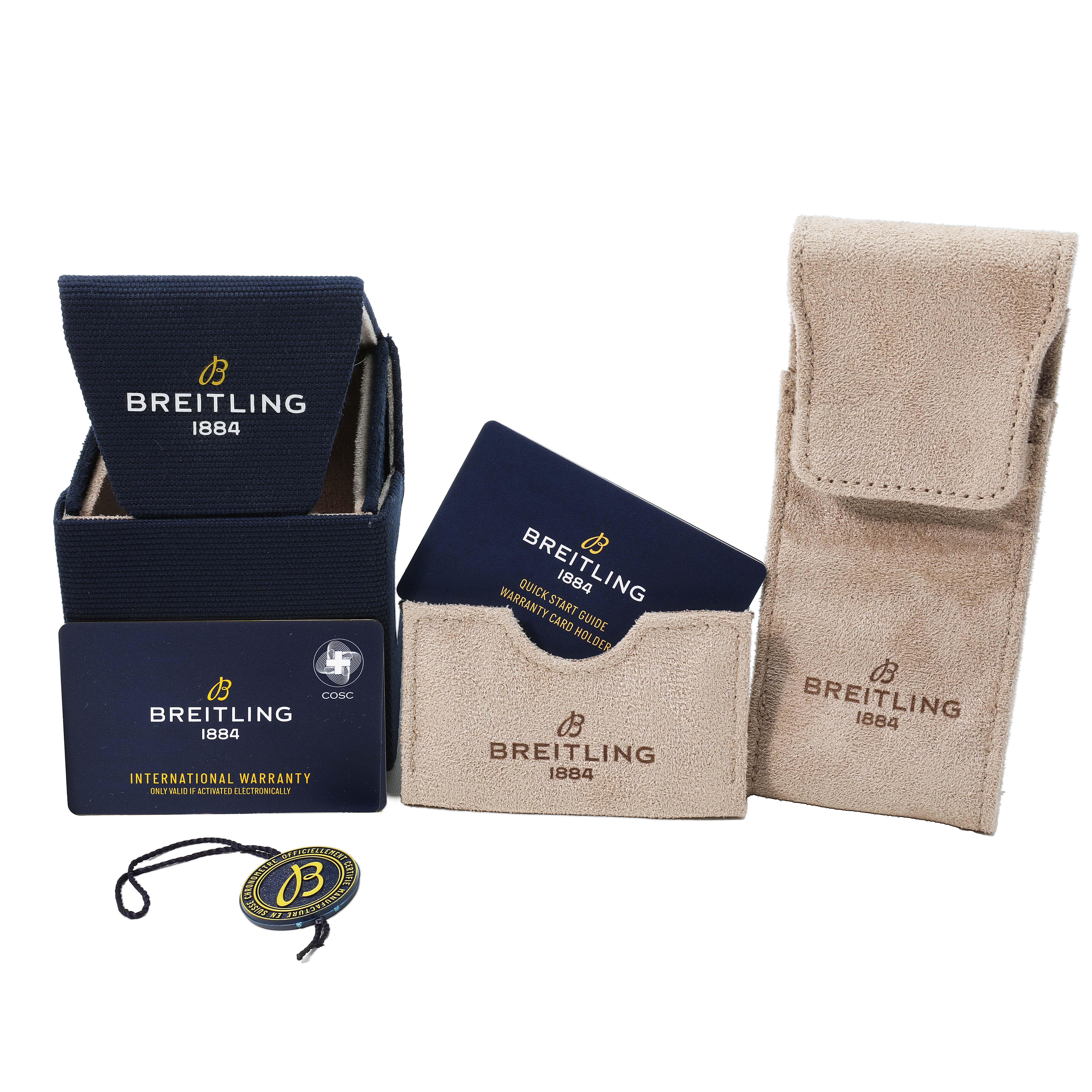 The image shows Breitling Navitimer A32310 Men's Stainless Steel Silver Dial watch packaging, including a box, a warranty card, a quick-start guide, and a travel pouch.