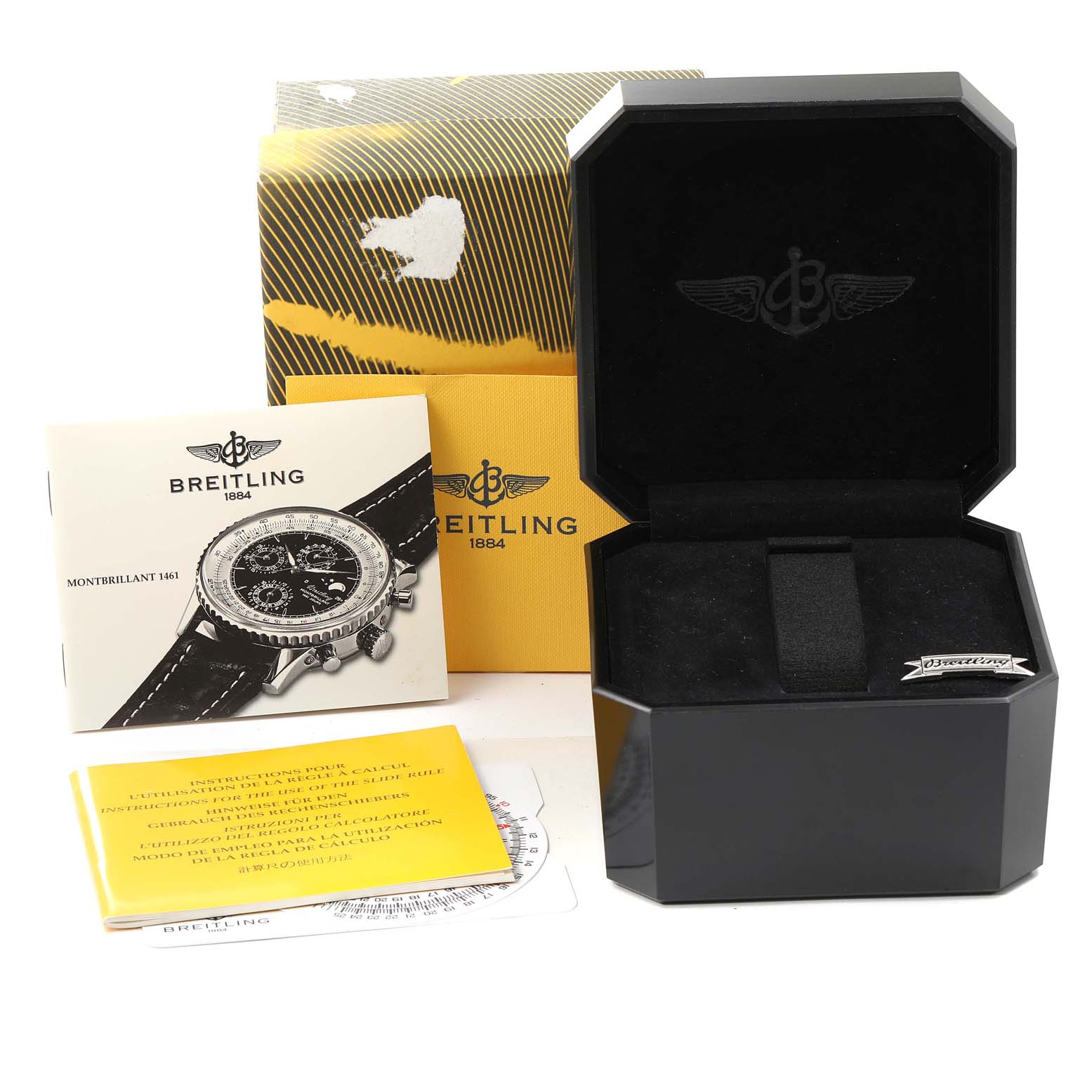 The image shows a packaging box, instruction manuals, and display case for the Navitimer by Breitling.