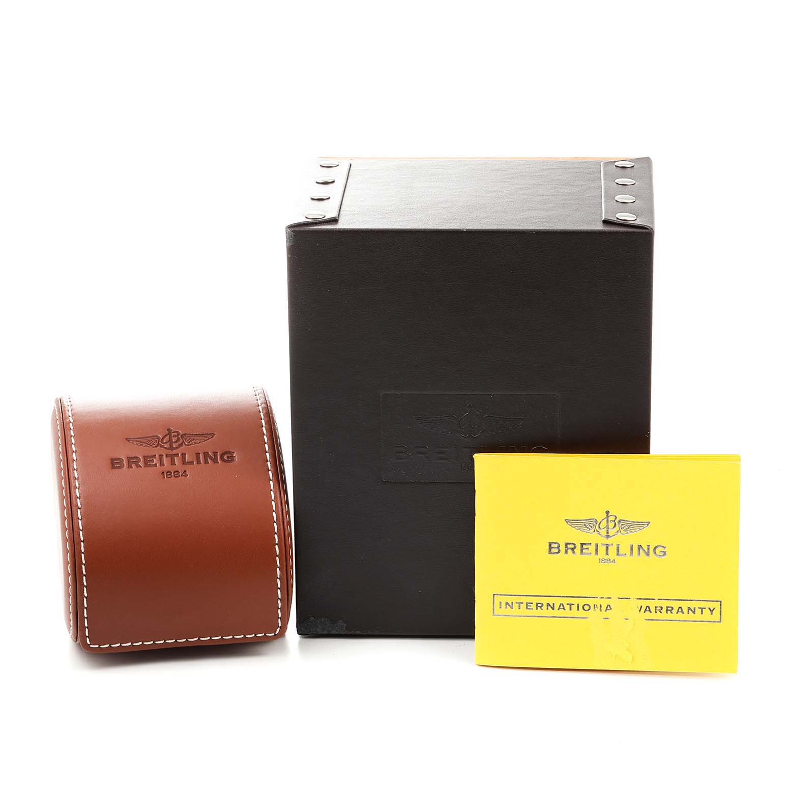 The image shows a Breitling Superocean A13311 Men
s Stainless Steel Black Dial A13311 Men
s Stainless Steel Black Dial watch box, a brown leather case, and an international warranty card.