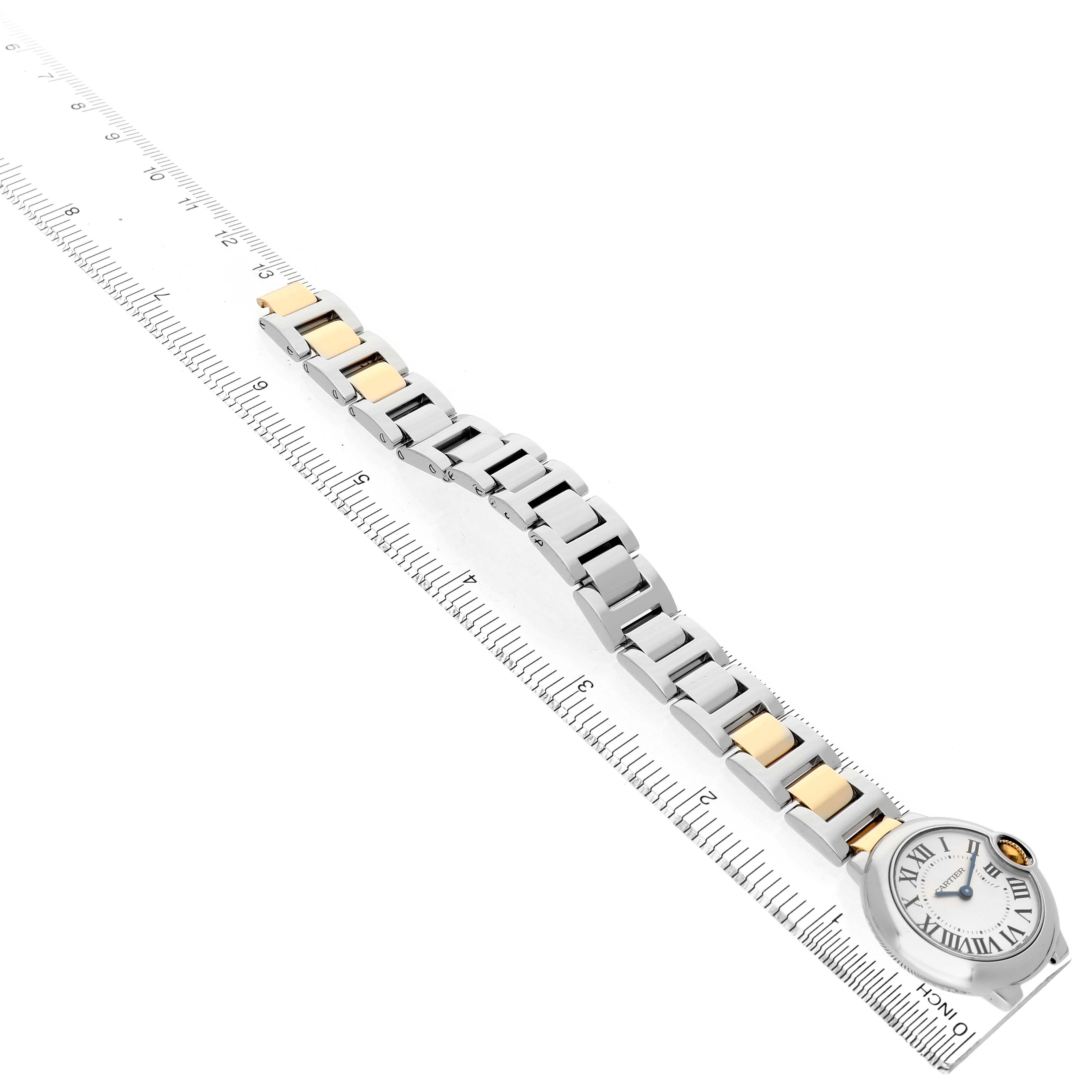 The image shows the Cartier Ballon Bleu W69007Z3 Women's Stainless Steel Silver Dial watch at an oblique angle, highlighting its two-tone bracelet and face alongside a ruler for scale.