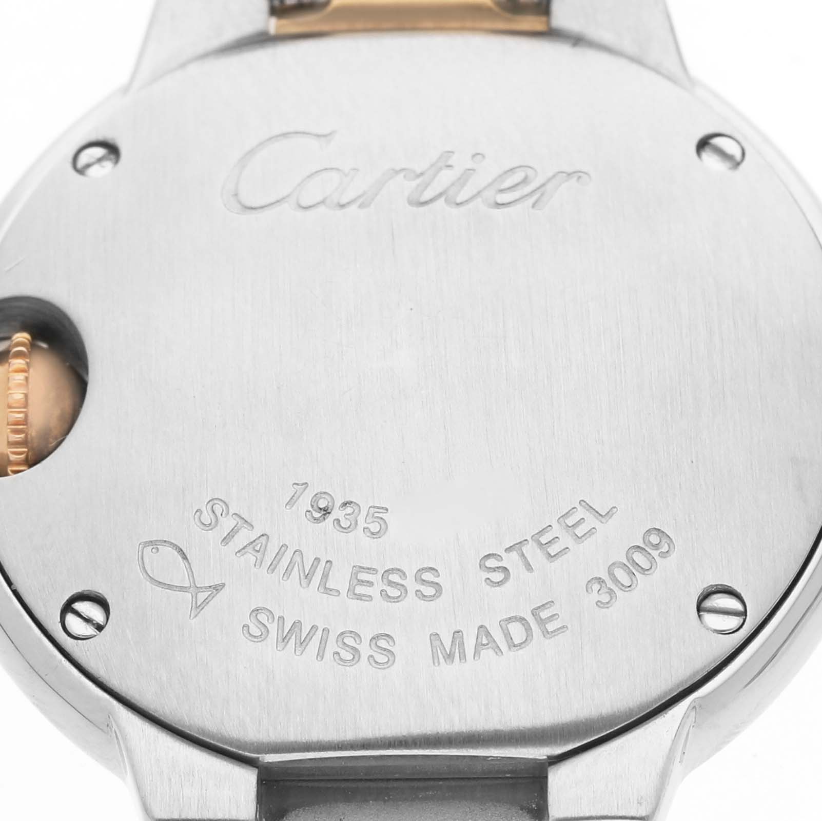 The image shows the back case of a Cartier Ballon Bleu W69007Z3 Women's Steel and Gold (two tone) Silver Dial watch with engraved details and the crown slightly visible.