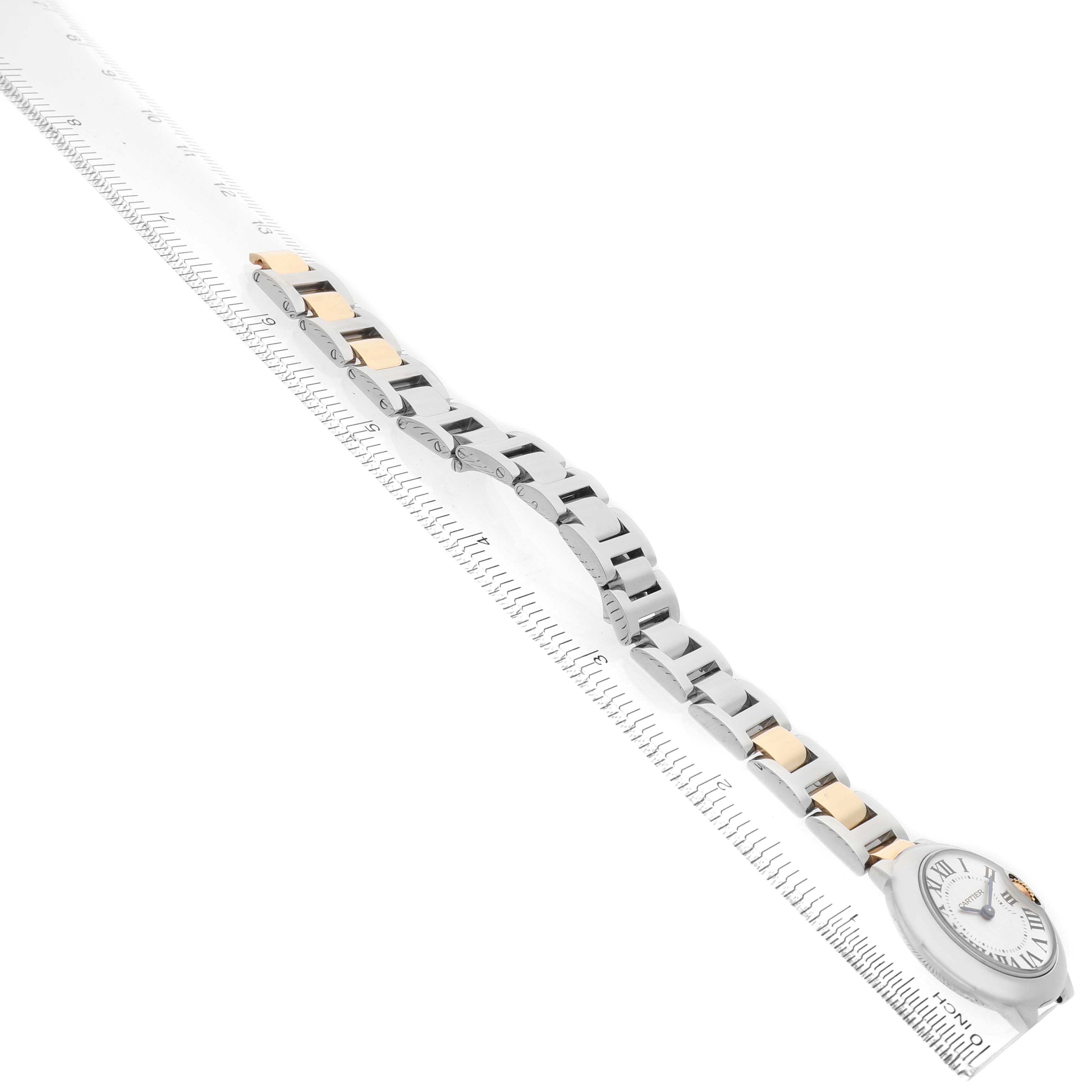 The Ballon Bleu by Cartier is shown from a side angle, displaying the face and part of the bracelet.