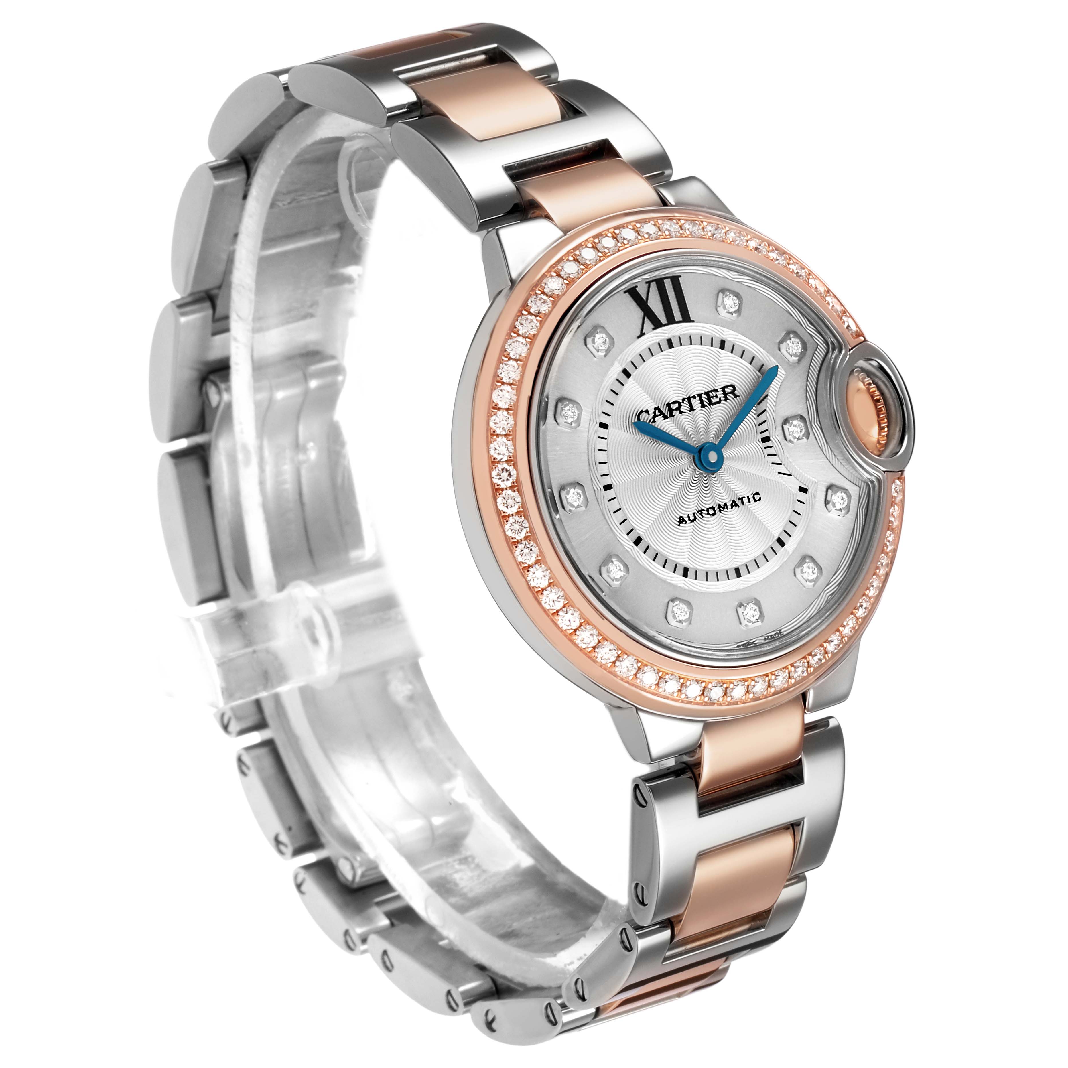 The Cartier Ballon Bleu WE902077 Women's Steel and Gold (two tone) Silver Dial watch is shown at a three-quarter angle, highlighting the face, bezel with diamonds, and two-tone bracelet.