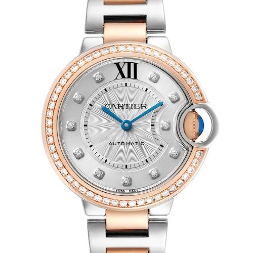 The Cartier Ballon Bleu WE902077 Women's Steel and Gold (two tone) Silver Dial watch is shown from the front, highlighting its diamond-studded bezel and blue sword-shaped hands.