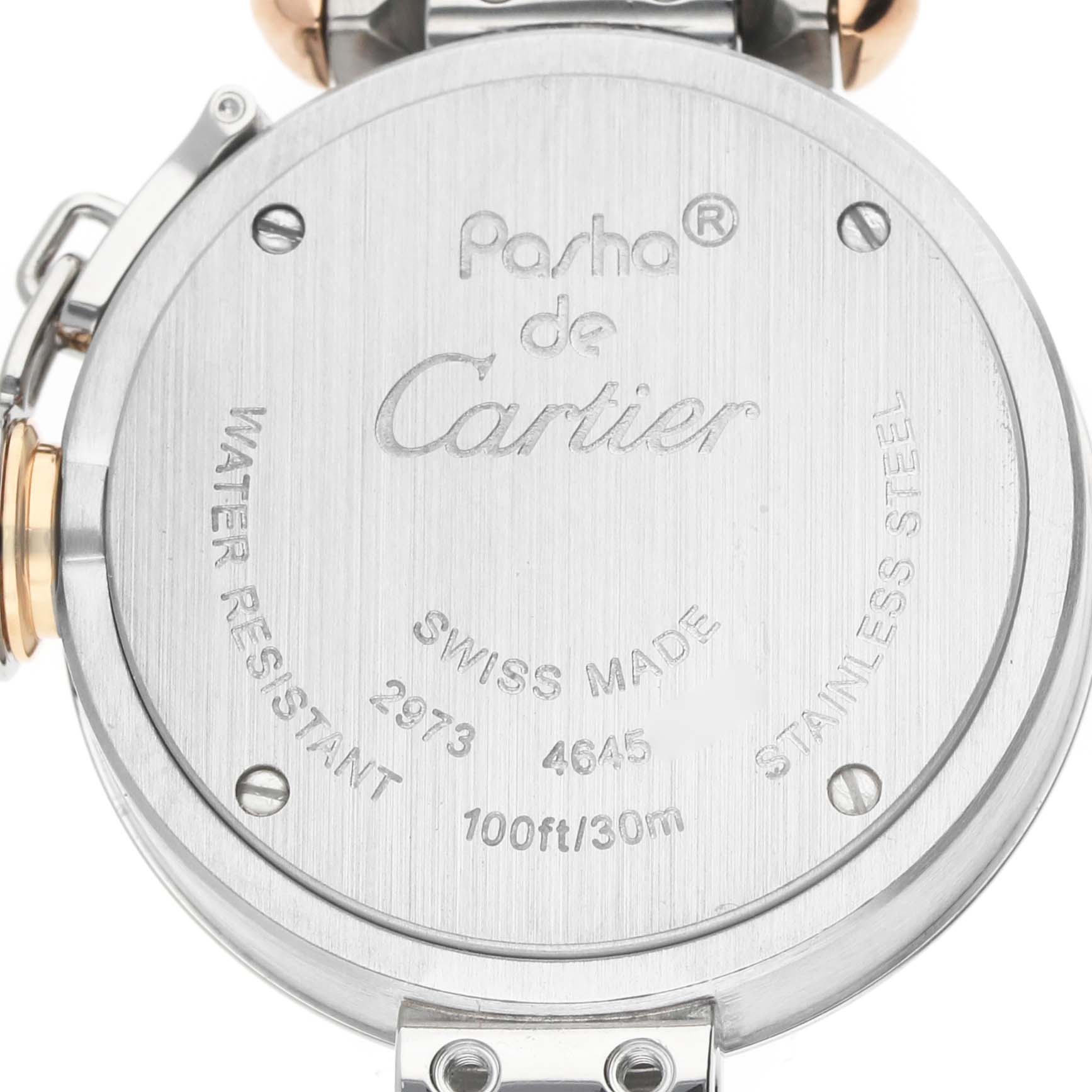 The image shows the back case of a Cartier Pasha WJ124020 Women's Steel and Gold (two tone) Silver Dial watch, highlighting engravings like "Swiss Made" and water resistance details.
