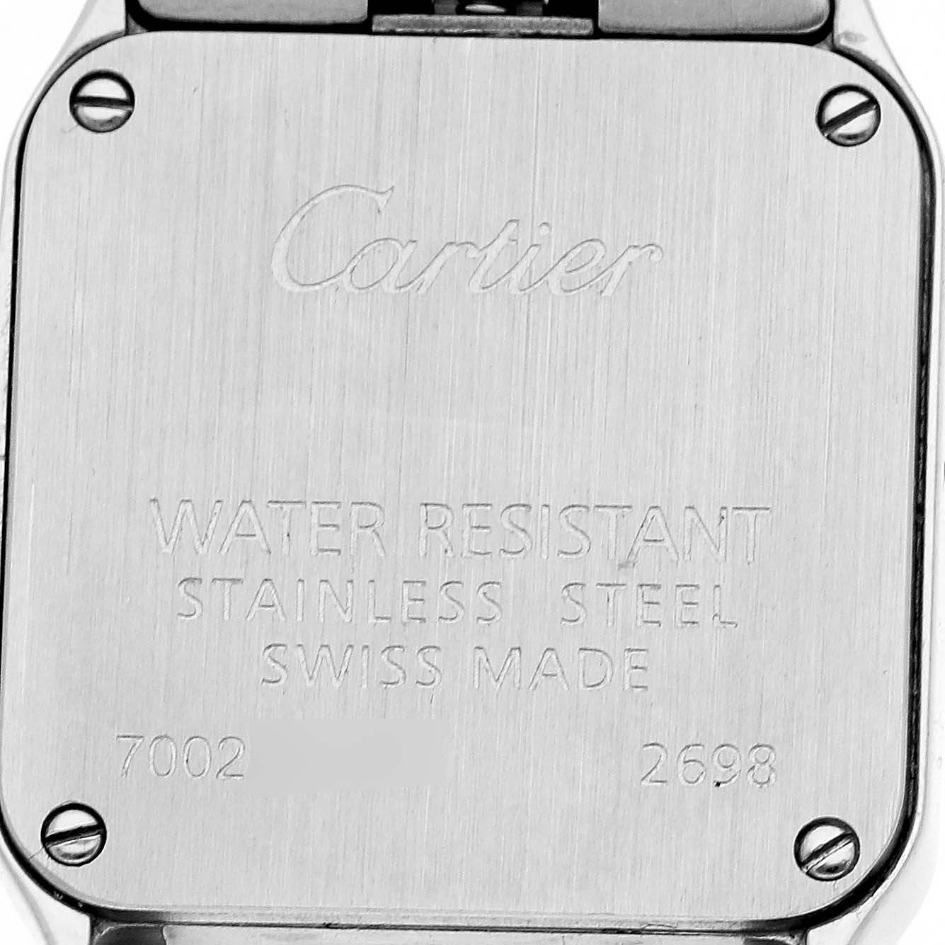 The image shows the back case of a Cartier Santos Demoiselle W25075Z5 Women's Stainless Steel Mother of Pearl Dial watch, featuring engravings and screws.