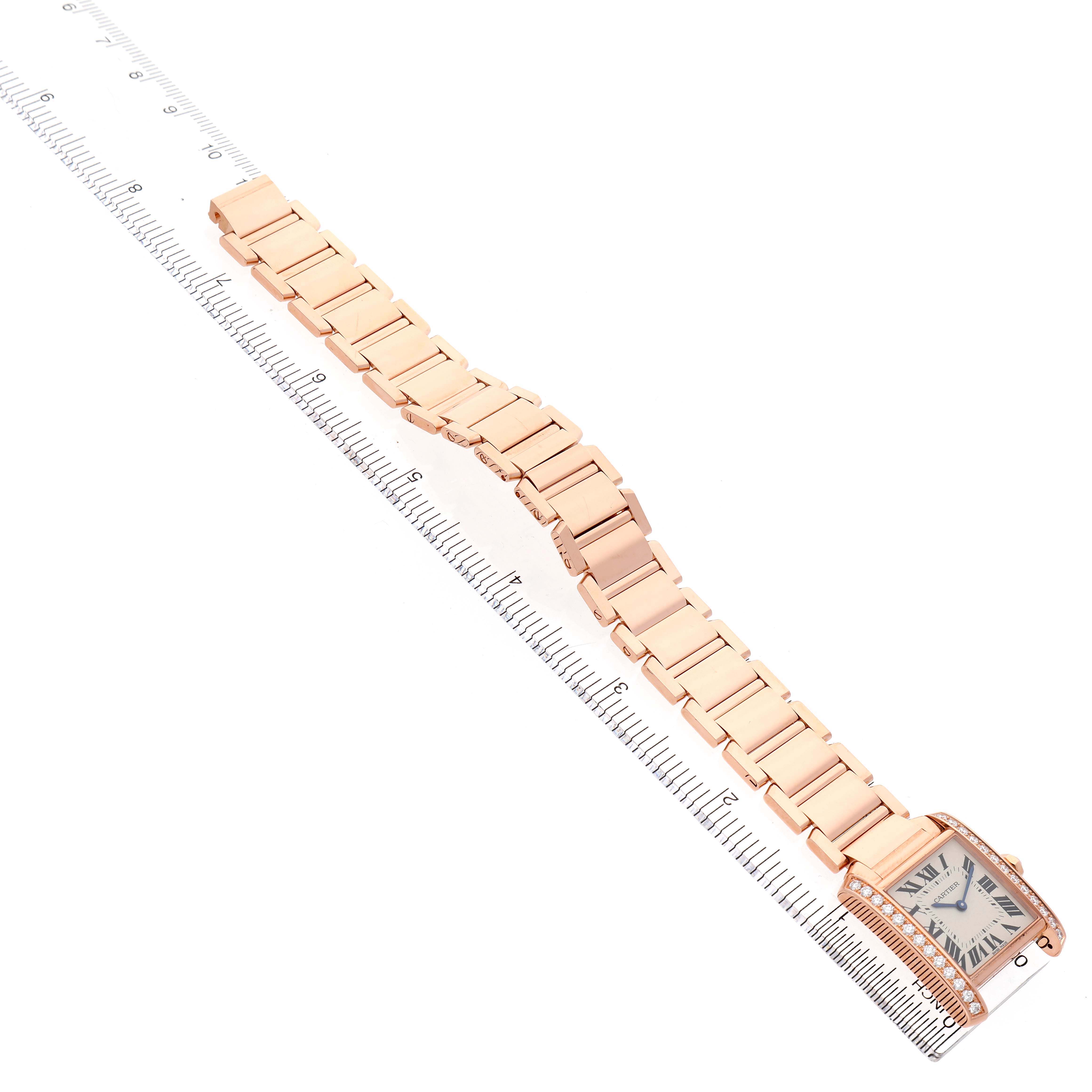 The Cartier Tank Française watch is shown at an angle, displaying the full gold bracelet and rectangular face with Roman numerals.