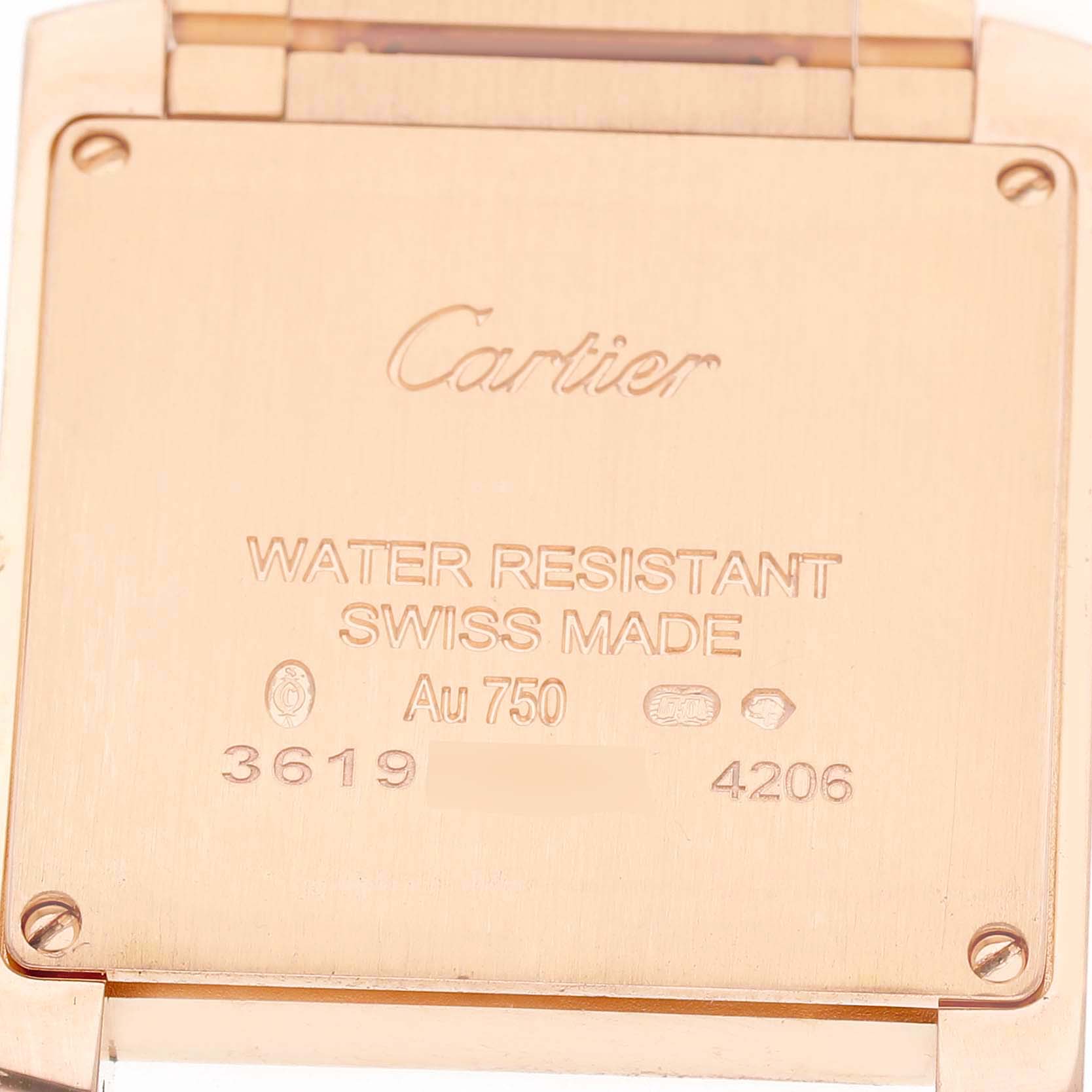 The image shows the back case of a Cartier Tank Française watch, featuring engraved details.