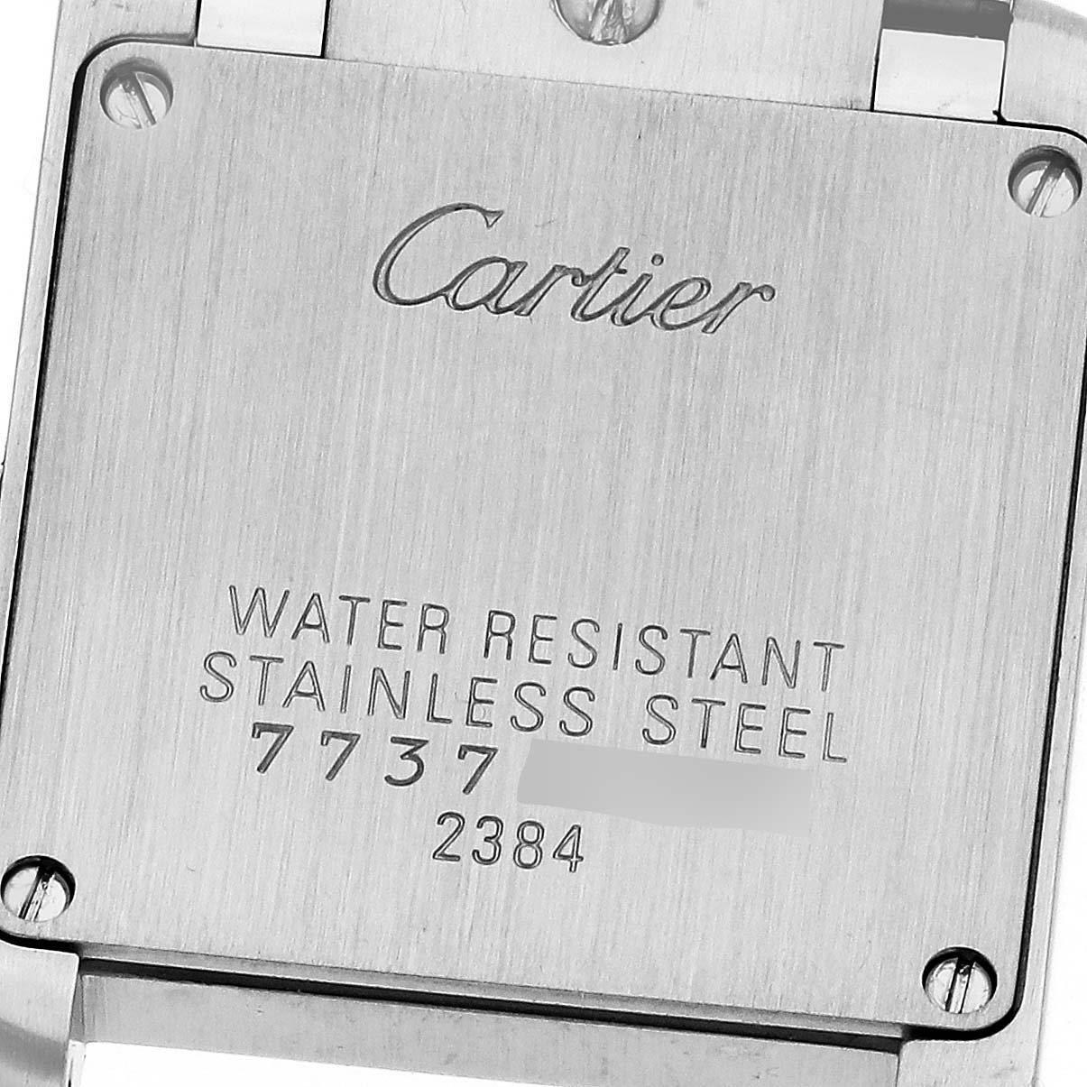 The image shows the back of a Cartier Tank Francaise W51027Q4 Women's Steel and Gold (two tone) Mother of Pearl Dial watch, featuring engravings and screws.
