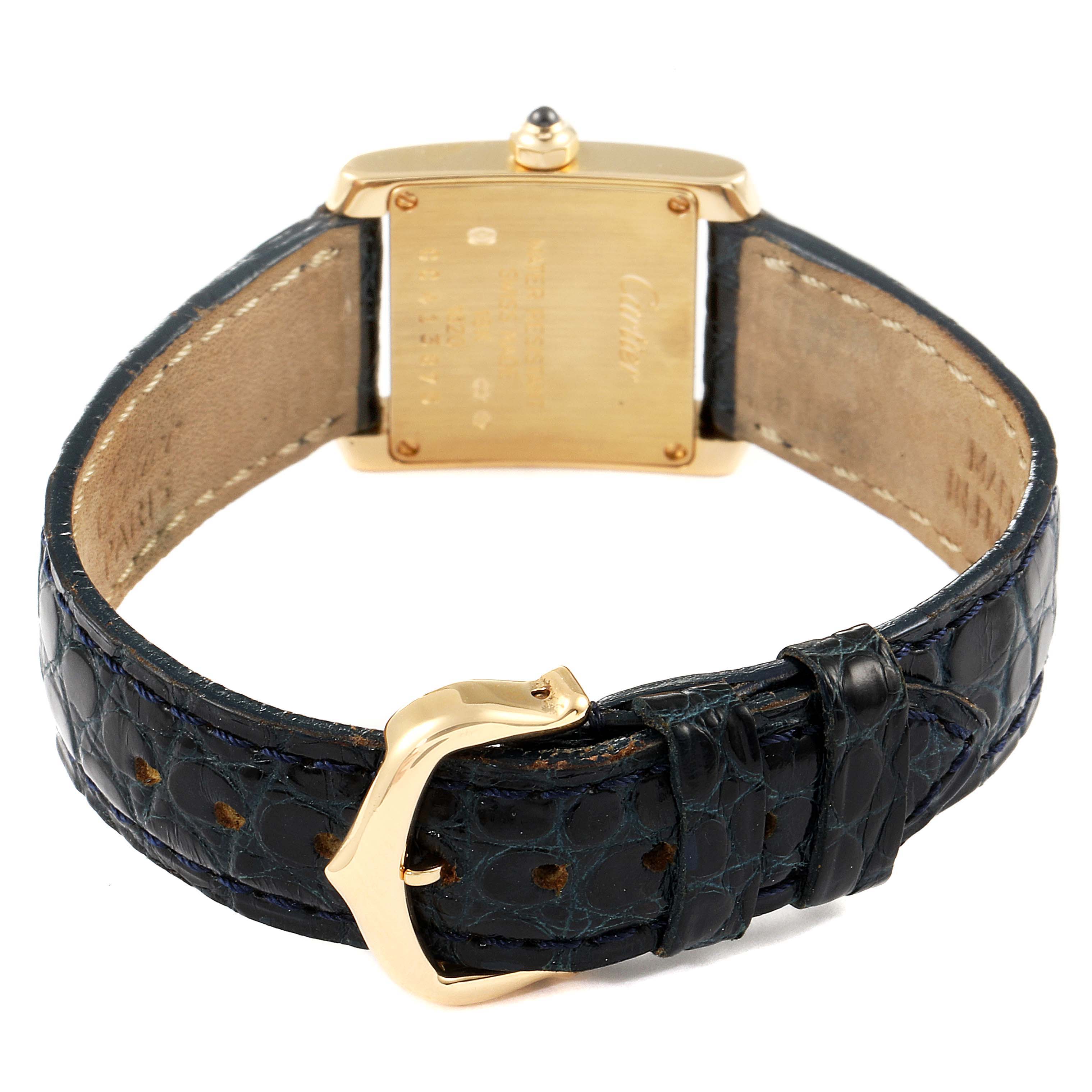 The image shows the back of a Cartier Tank Francaise W5000256 Women's Yellow Gold Silver Dial W5000256 Women's Yellow Gold Silver Dial watch, highlighting the case back and leather strap with a gold buckle.