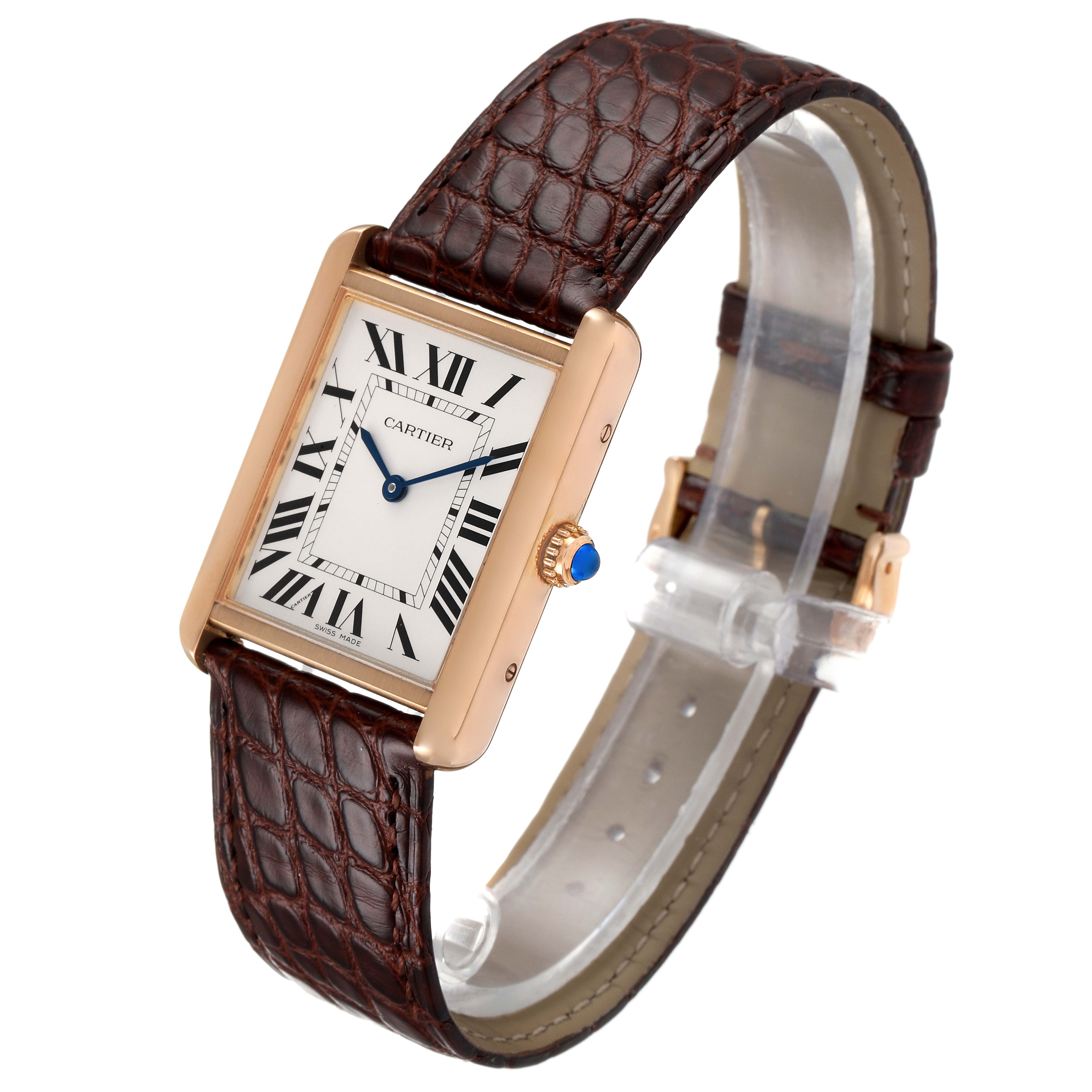 The Cartier Tank Solo W5200025 Men's Rose Gold Silver Dial W5200025 Men's Rose Gold Silver Dial watch is shown at a slight angle, highlighting its rectangular face, brown strap, and blue-tipped crown.