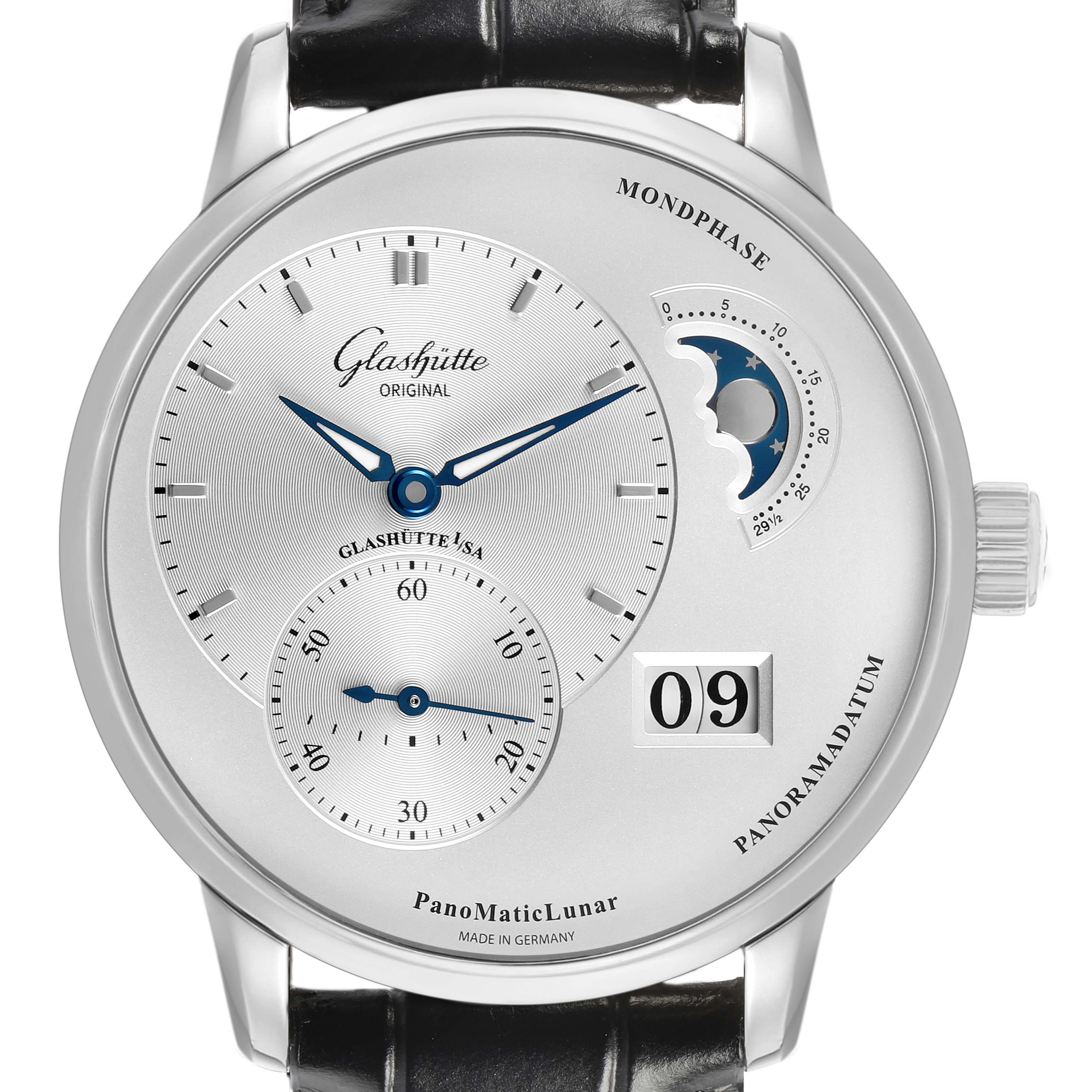 The Glashütte Pano watch is shown from a front angle, highlighting its off-center dials, moon phase, and date display.