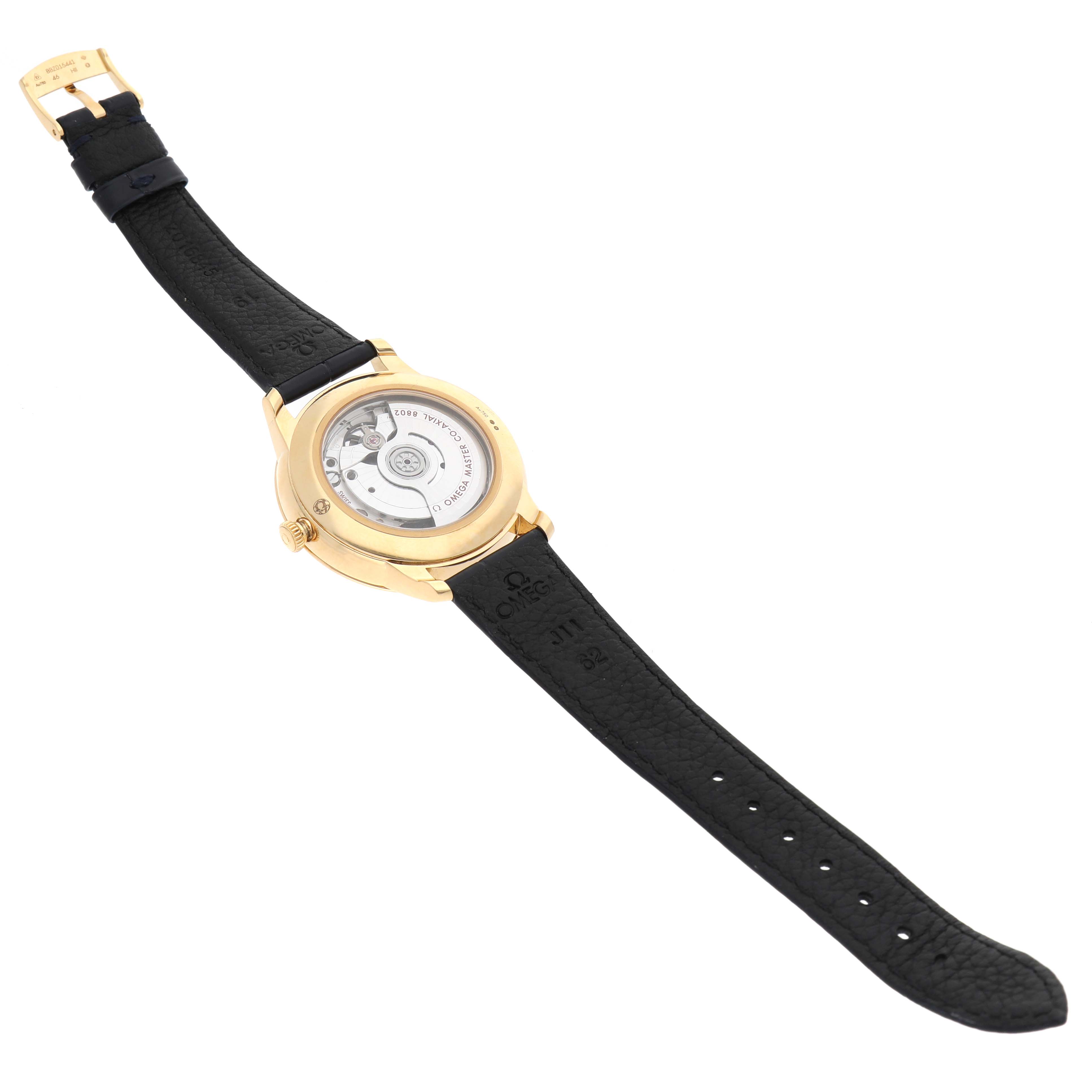 The Omega De Ville 434.53.41.20.02.001 Men's Yellow Gold Silver Dial watch is shown from the back, revealing the case back and movement with a black leather strap.