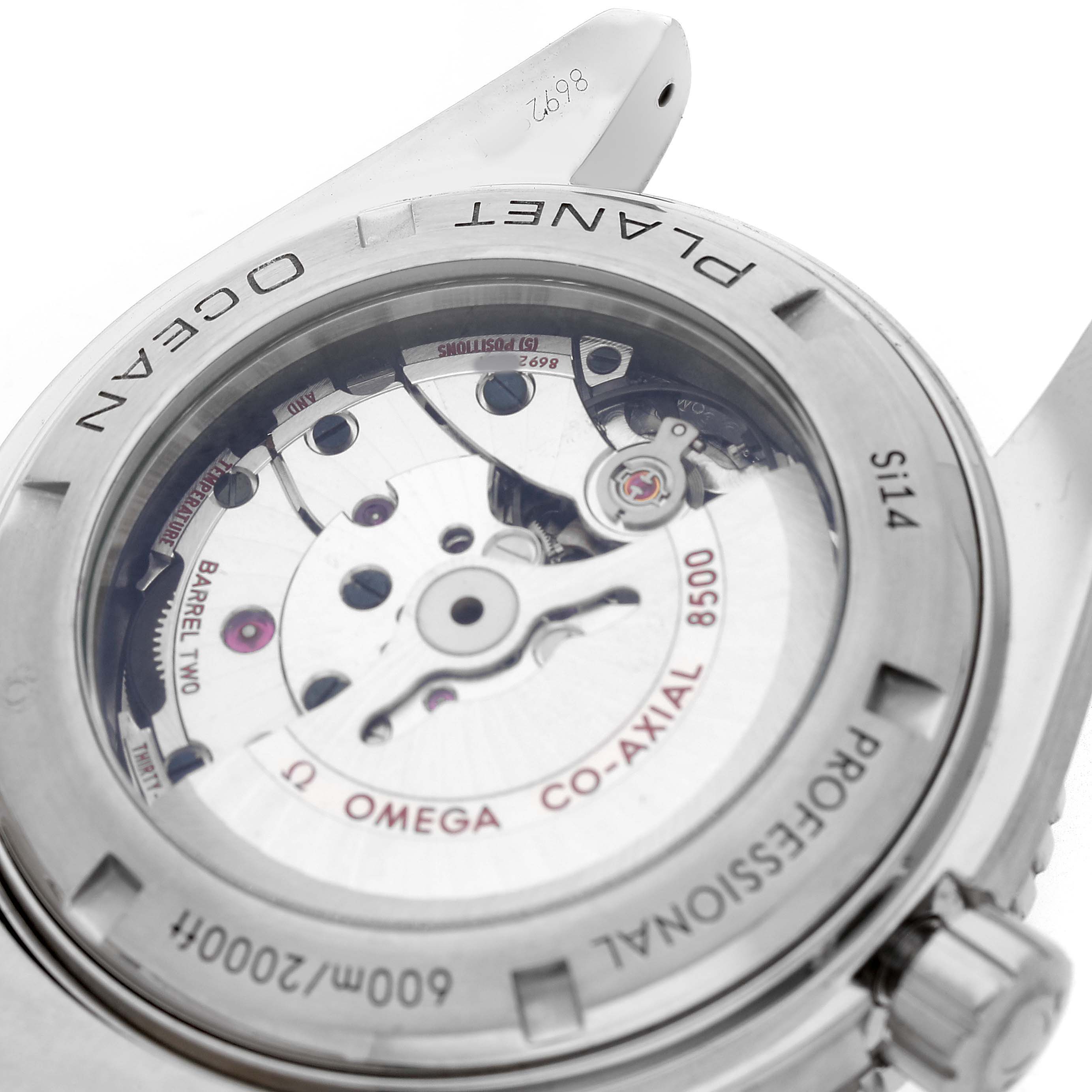 The image shows a rear view of the Omega Planet Ocean 232.30.46.21.01.001 Men's Stainless Steel Black Dial watch, highlighting its Co-Axial 8500 movement through a transparent case back.