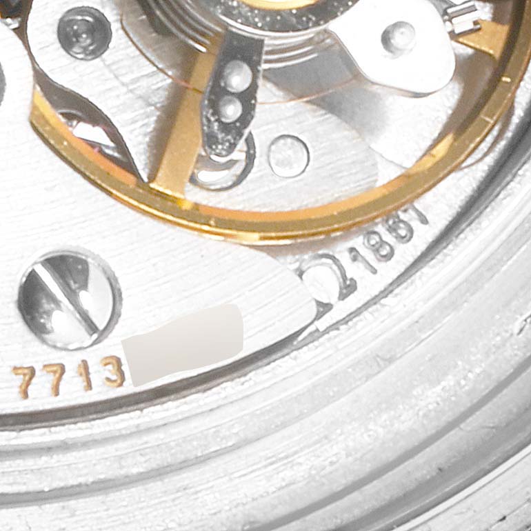 Close-up view of the Omega Speedmaster 3570.50.00 Men
s Stainless Steel Black Dial 3570.50.00 Men
s Stainless Steel Black Dial watch movement, showing gears and engraved serial number.