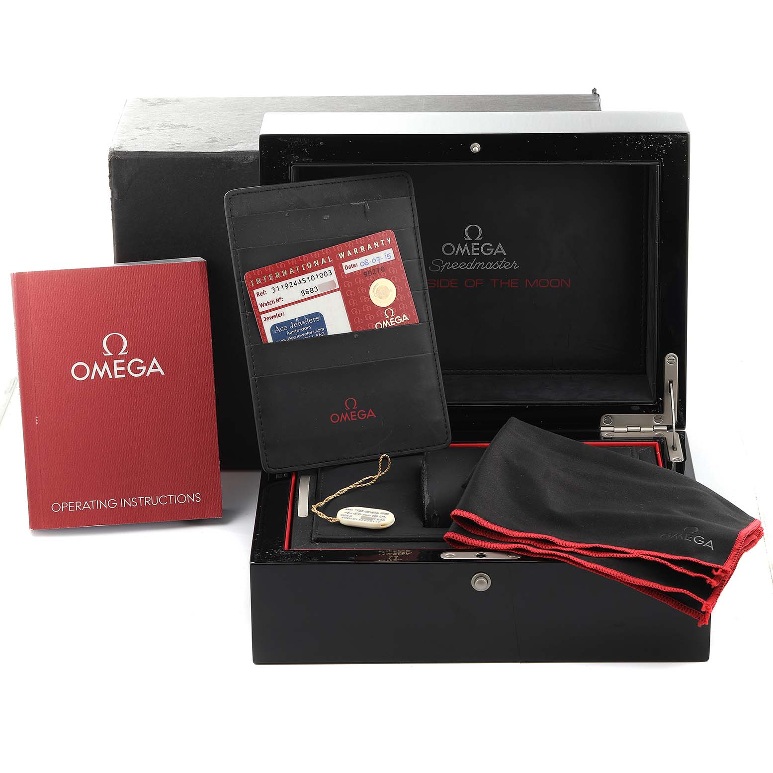 The image shows an Omega Speedmaster 311.92.44.51.01.003 Men
s Ceramic Black Dial 311.92.44.51.01.003 Men
s Ceramic Black Dial watch box, operating instructions, warranty cards, and a cleaning cloth.