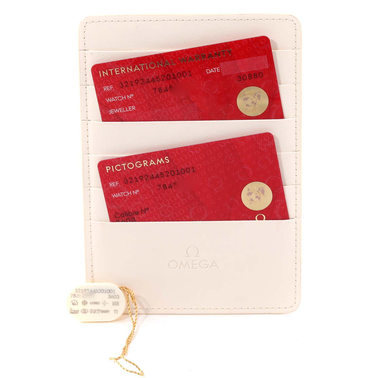 This image shows the warranty cards and case for an Omega Speedmaster 321.92.44.52.01.001 Men's Titanium Black Dial 321.92.44.52.01.001 Men's Titanium Black Dial watch from a top-down angle.