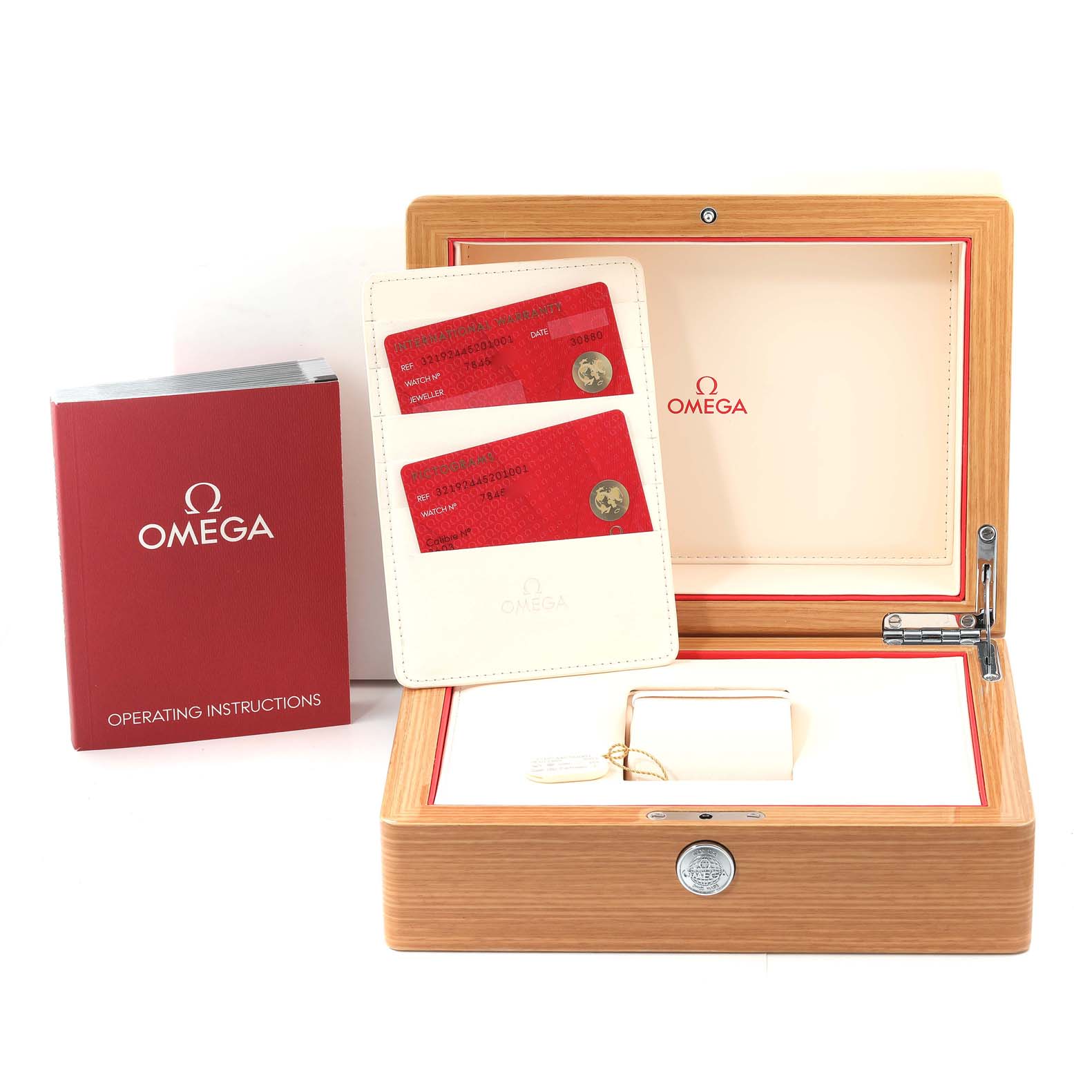 The image shows an open Omega Speedmaster 321.92.44.52.01.001 Men's Titanium Black Dial 321.92.44.52.01.001 Men's Titanium Black Dial watch box, with operating instructions and warranty cards placed nearby.