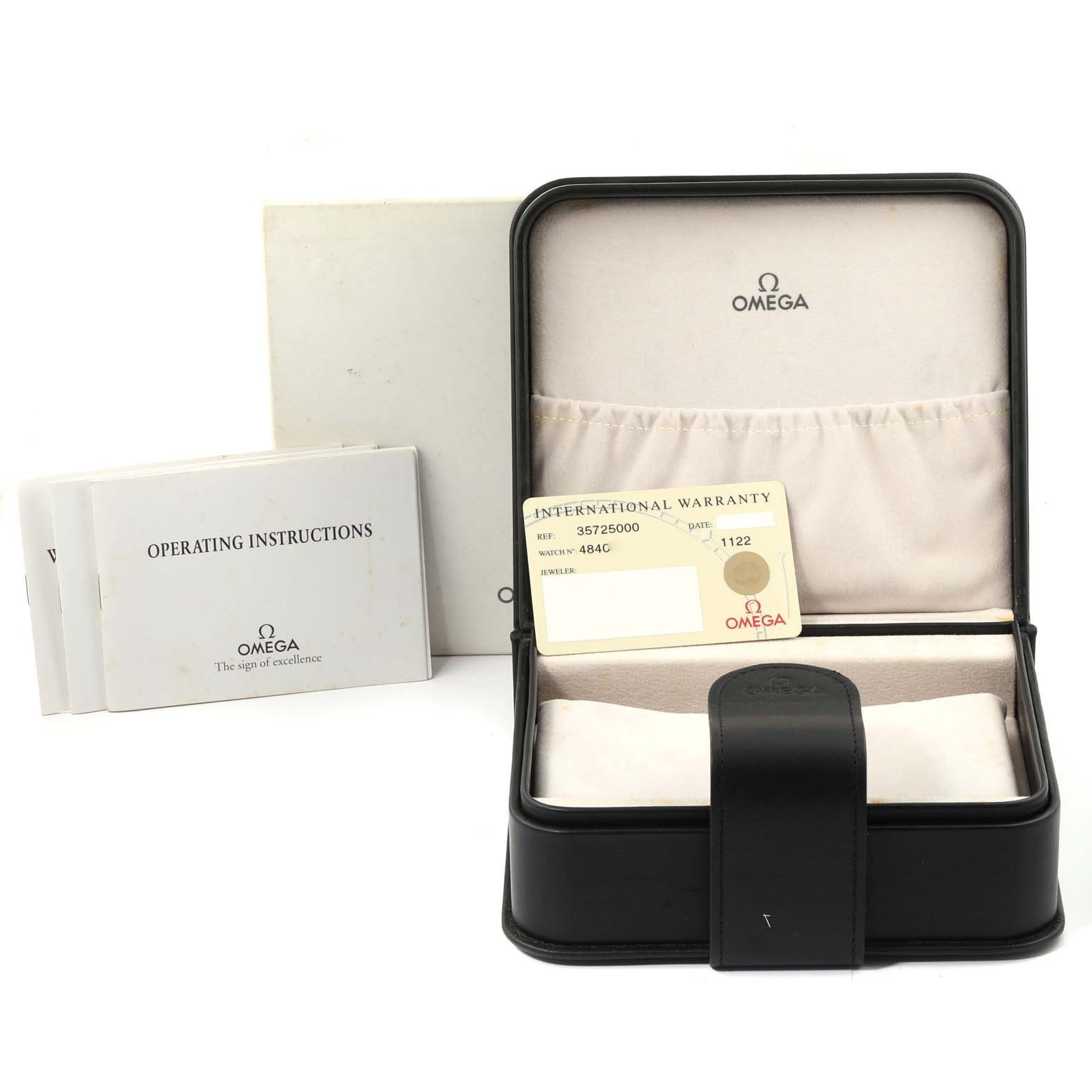 The image shows the packaging of an Omega Speedmaster 3572.50.00 Men
s Stainless Steel Black Dial 3572.50.00 Men
s Stainless Steel Black Dial, including the watch box, warranty card, and operating instructions.