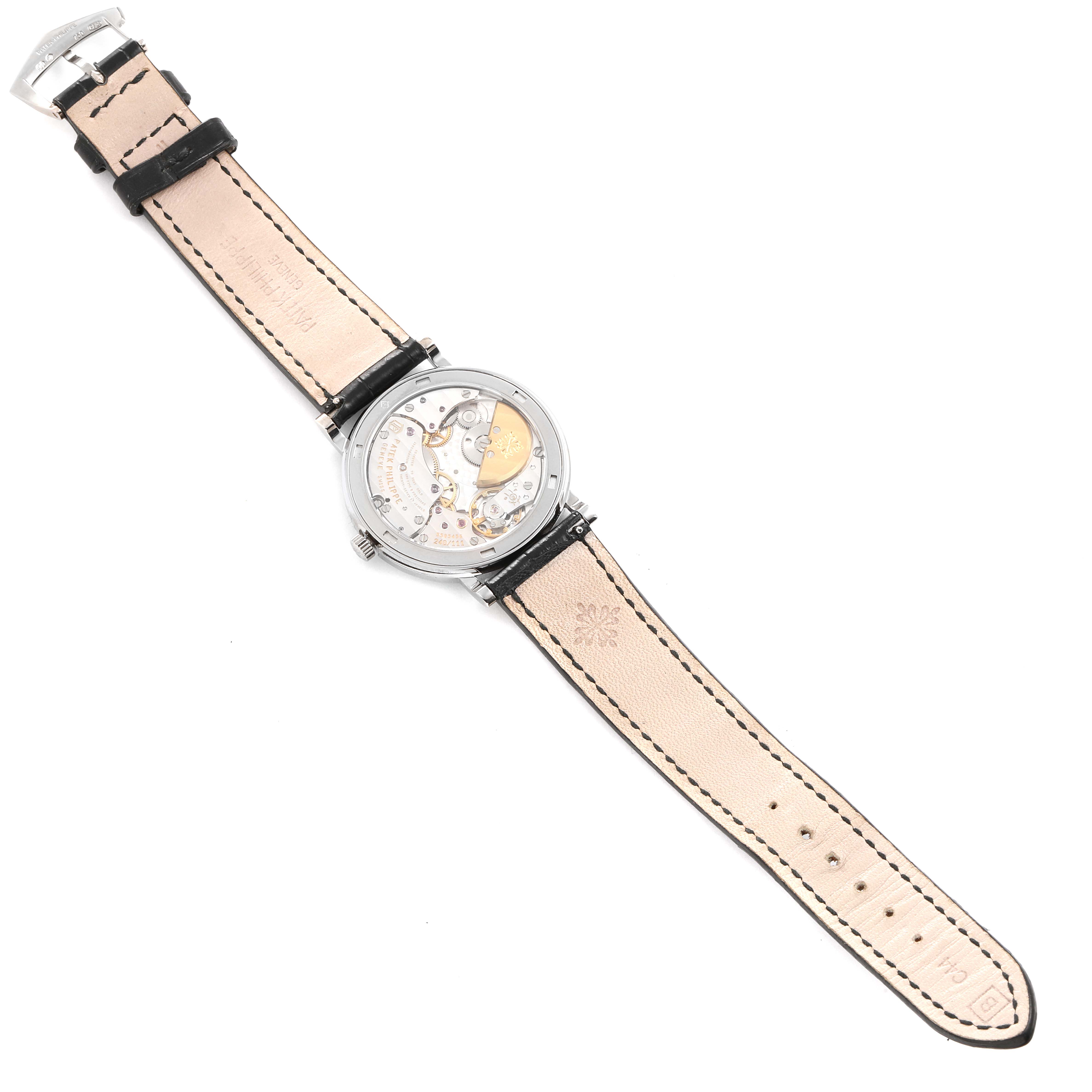 The image shows the back view of a Patek Philippe Calatrava 5120G Men's White Gold White Dial 5120G Men's White Gold White Dial watch, highlighting the inner mechanics and leather strap.