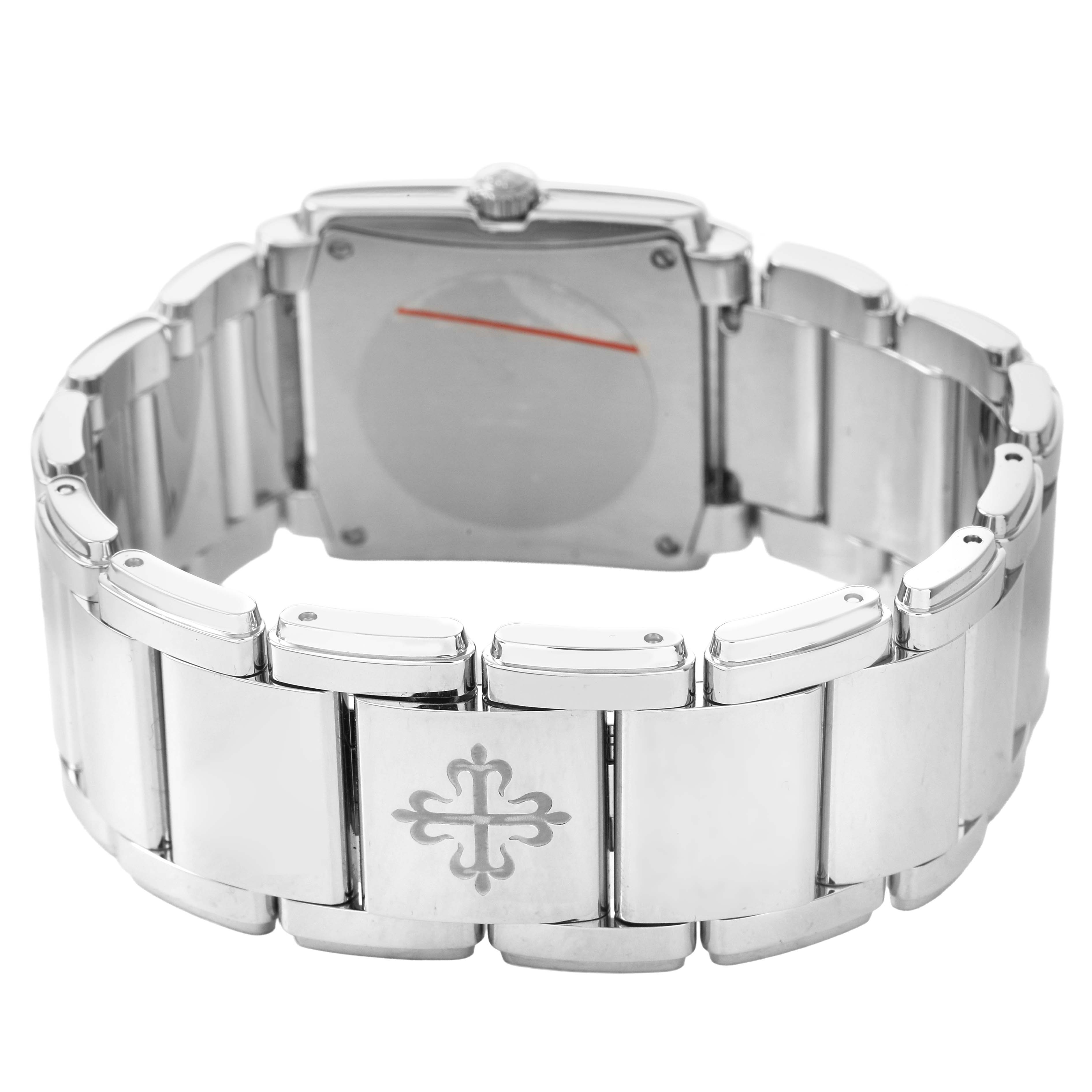 The image shows the back view of the Patek Philippe Twenty-4 4910A Women's Stainless Steel Green Dial watch, highlighting its bracelet and clasp with an engraved logo.
