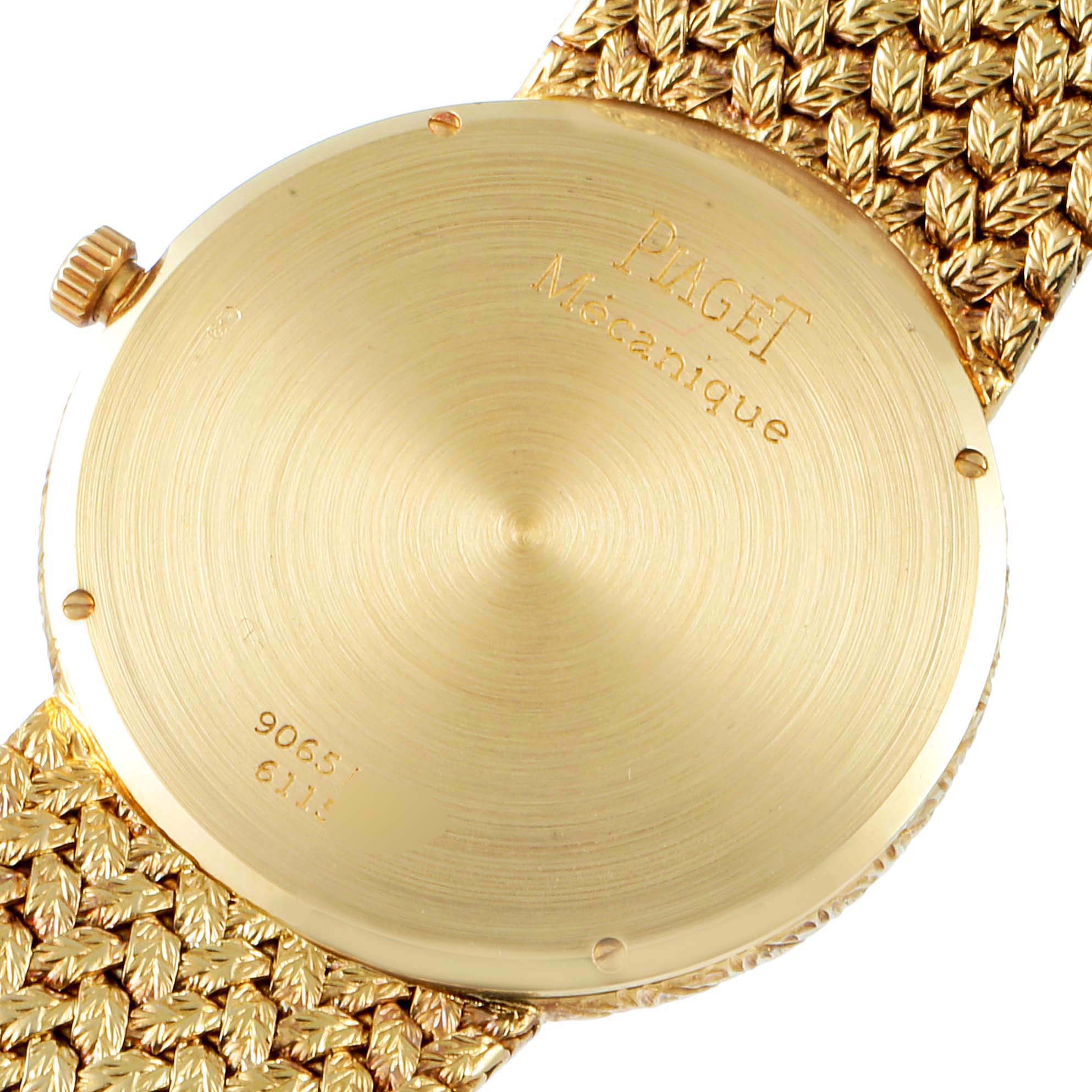 The image shows the case back and crown of the Piaget 9065 ND 2 Men's Yellow Gold Champagne Dial 9065 ND 2 Men's Yellow Gold Champagne Dial 9065 model 18k Yellow Gold Champagne Dial Vintage Men's Watch.