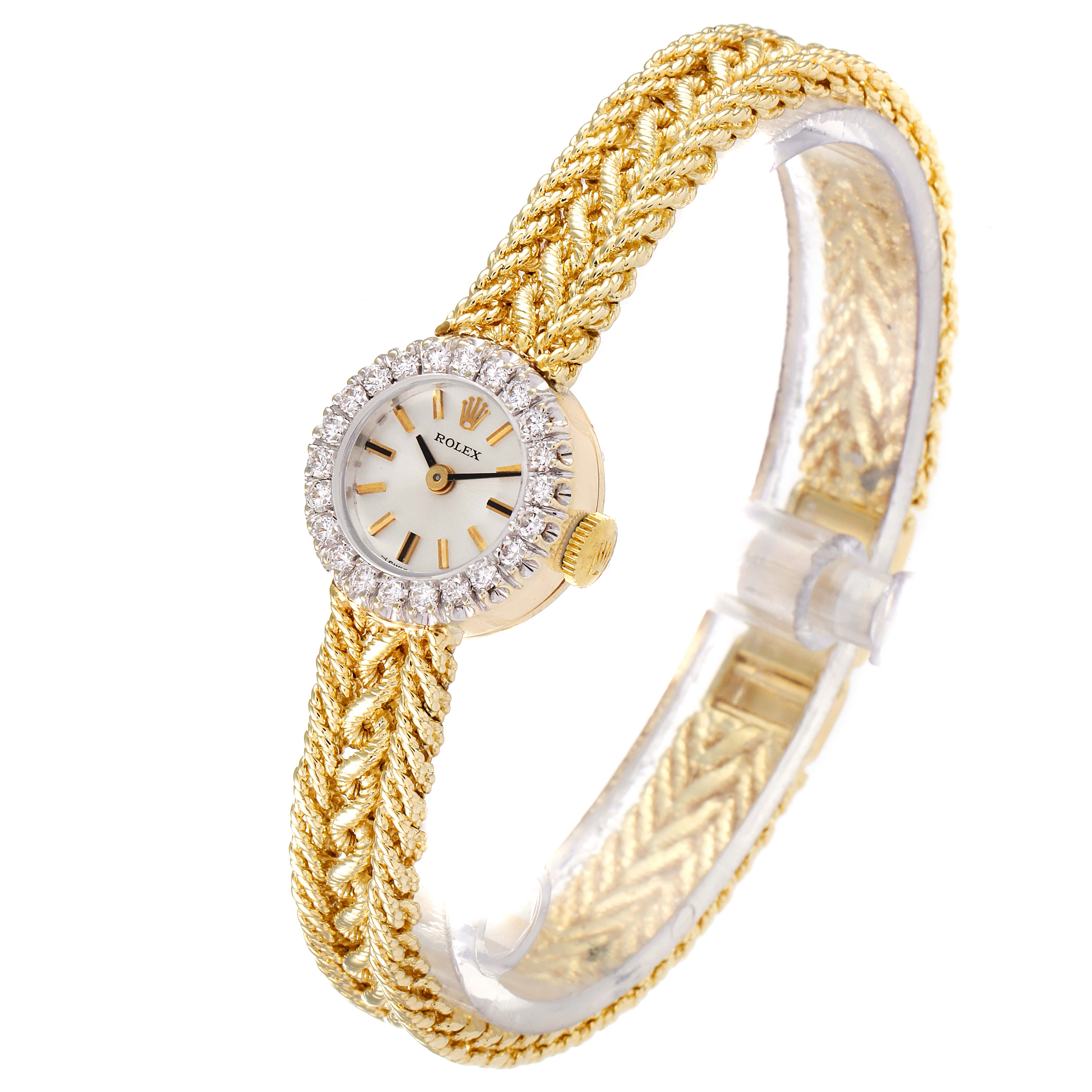The Rolex Cocktail 32369 Women's Yellow Gold Silver Dial 32369 Women's Yellow Gold Silver Dial watch is displayed at a slight angle, showing its woven gold band, diamond bezel, and elegant small dial.