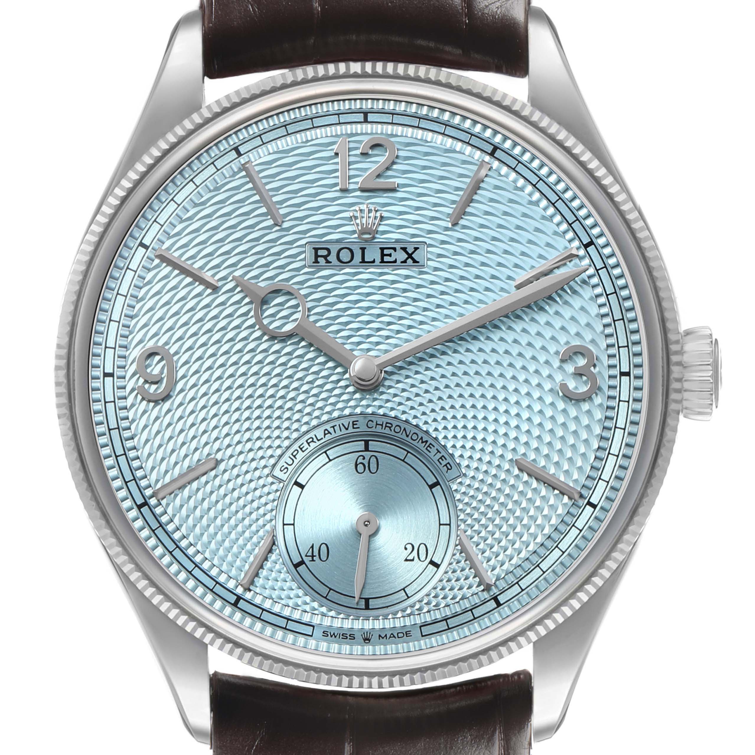 The Rolex 1908 52506 Men's Platinum Blue Dial model watch is shown from the front, displaying the light blue textured dial, brown leather strap, and silver hands.
