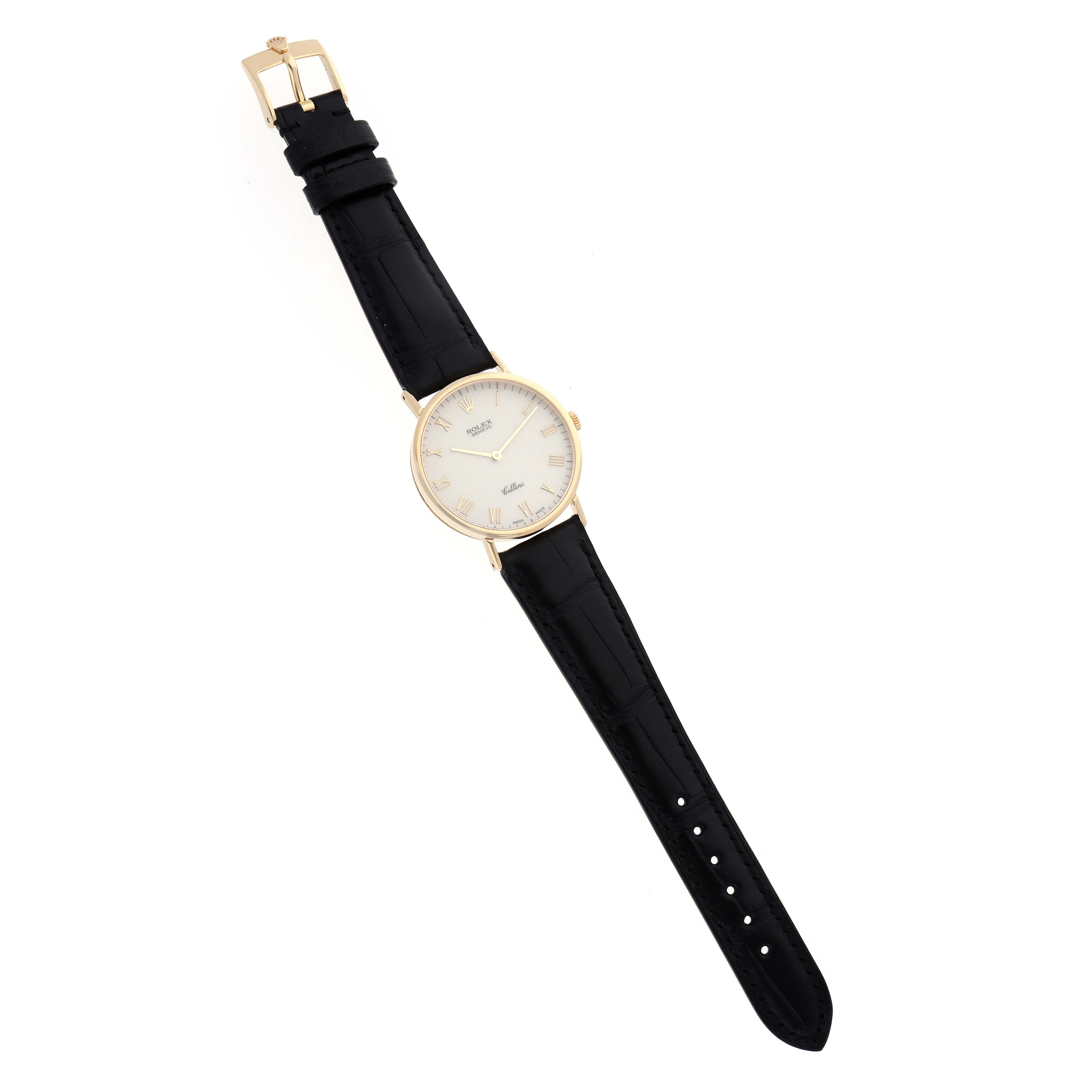 The Rolex Cellini 5112 Men
s Yellow Gold White Dial 5112 Men
s Yellow Gold White Dial watch is shown from a top-down angle, displaying the black leather strap and gold case with a white dial.