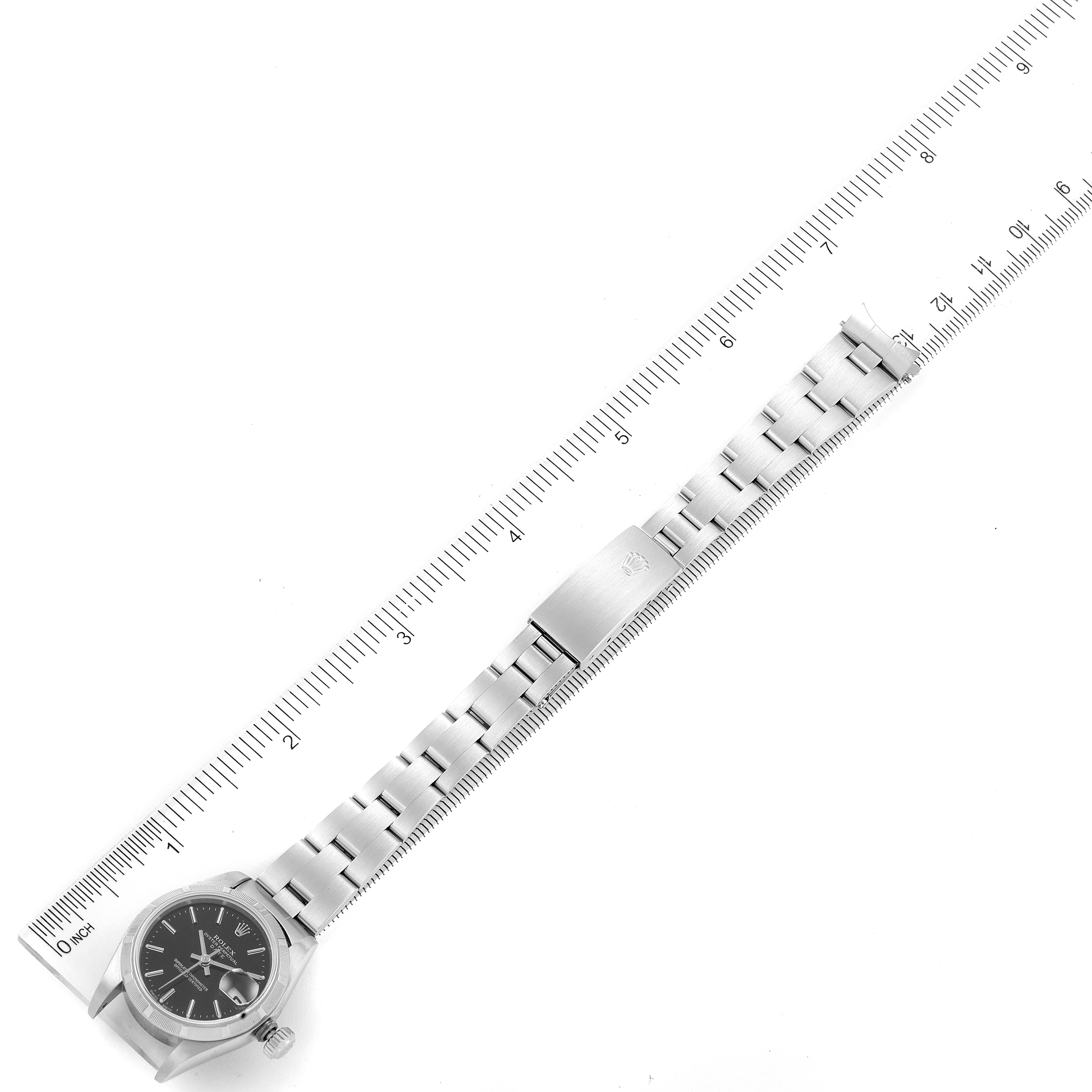 The image shows a Rolex Date 79190 Women's Stainless Steel Black Dial 79190 Women's Stainless Steel Black Dial model watch laid flat with a ruler to its left for measurement.