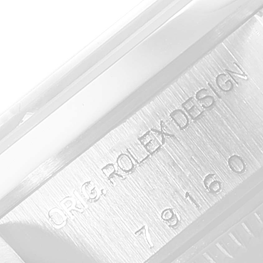 The image shows a close-up of the engraved model number and brand design text on a Rolex Date 79160 Women's Stainless Steel Silver Dial 79160 Women's Stainless Steel Silver Dial watch case.