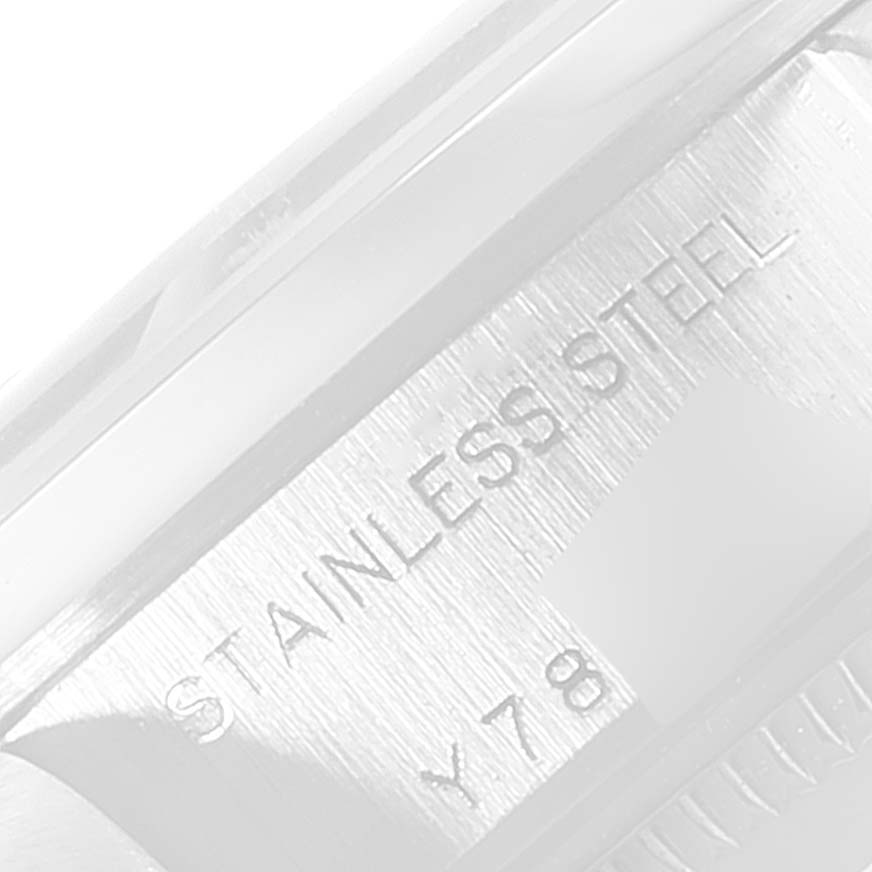 This is an extreme close-up of the side of the case for the Rolex Date 79160 Women's Stainless Steel Silver Dial 79160 Women's Stainless Steel Silver Dial model watch, showing the "STAINLESS STEEL" engraving.