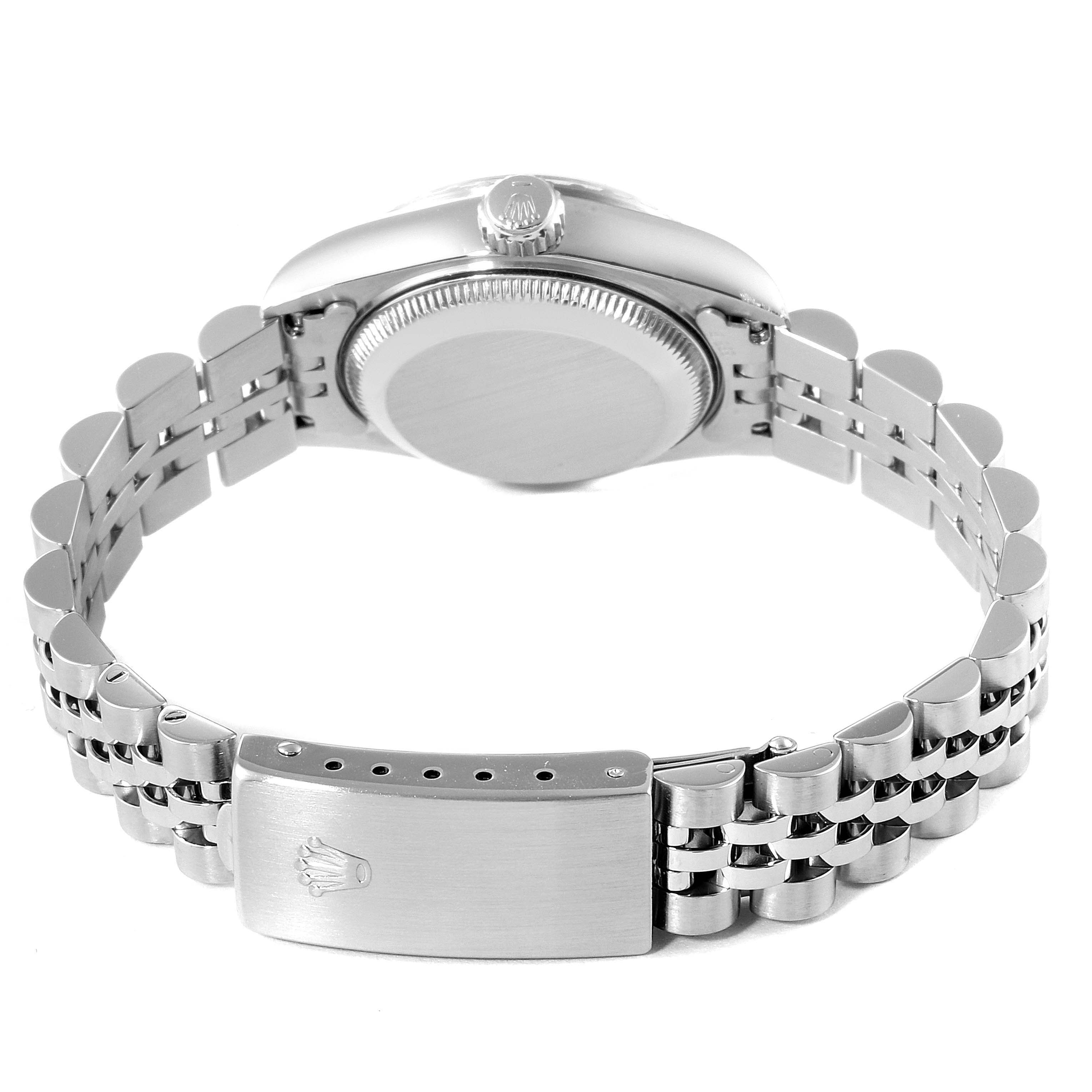 The image shows the back and side view of a Rolex Date 69240 Women's Stainless Steel White Dial 69240 Women's Stainless Steel White Dial model watch, highlighting its clasp, bracelet, crown, and case back.