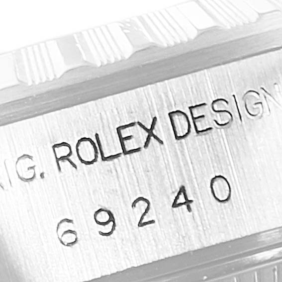 This close-up shows the case reference number and "ROLEX DESIGN" engraving on a Rolex Date 69240 Women's Stainless Steel White Dial 69240 Women's Stainless Steel White Dial model.