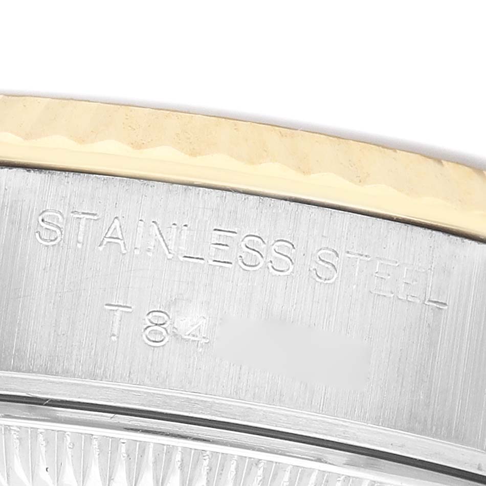 The image shows a close-up of the Rolex Datejust 69173 Women's Steel and Gold (two tone) Champagne Dial's stainless steel case, focusing on engraved text and part of the bezel.