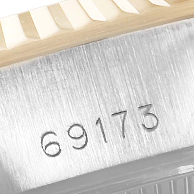 The image shows a close-up of the model number 69173 and part of the fluted bezel for the Rolex Datejust 69173 Women
s Steel and Gold (two tone) Champagne Dial 69173 Women
s Steel and Gold (two tone) Champagne Dial watch.