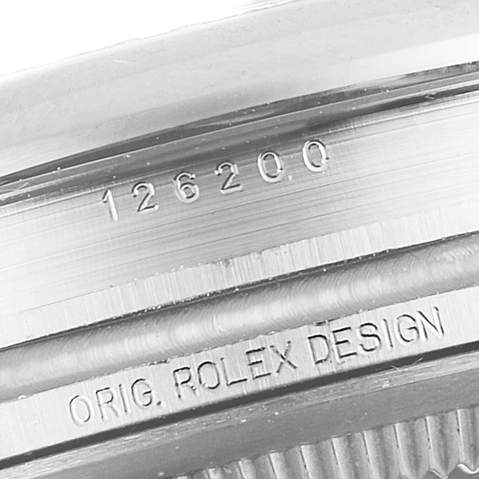 This image shows the side view of a Rolex Datejust 126200 Men
s Stainless Steel Blue Dial 126200 Men
s Stainless Steel Blue Dial with engraved model number 126200 and "Orig. Rolex Design".