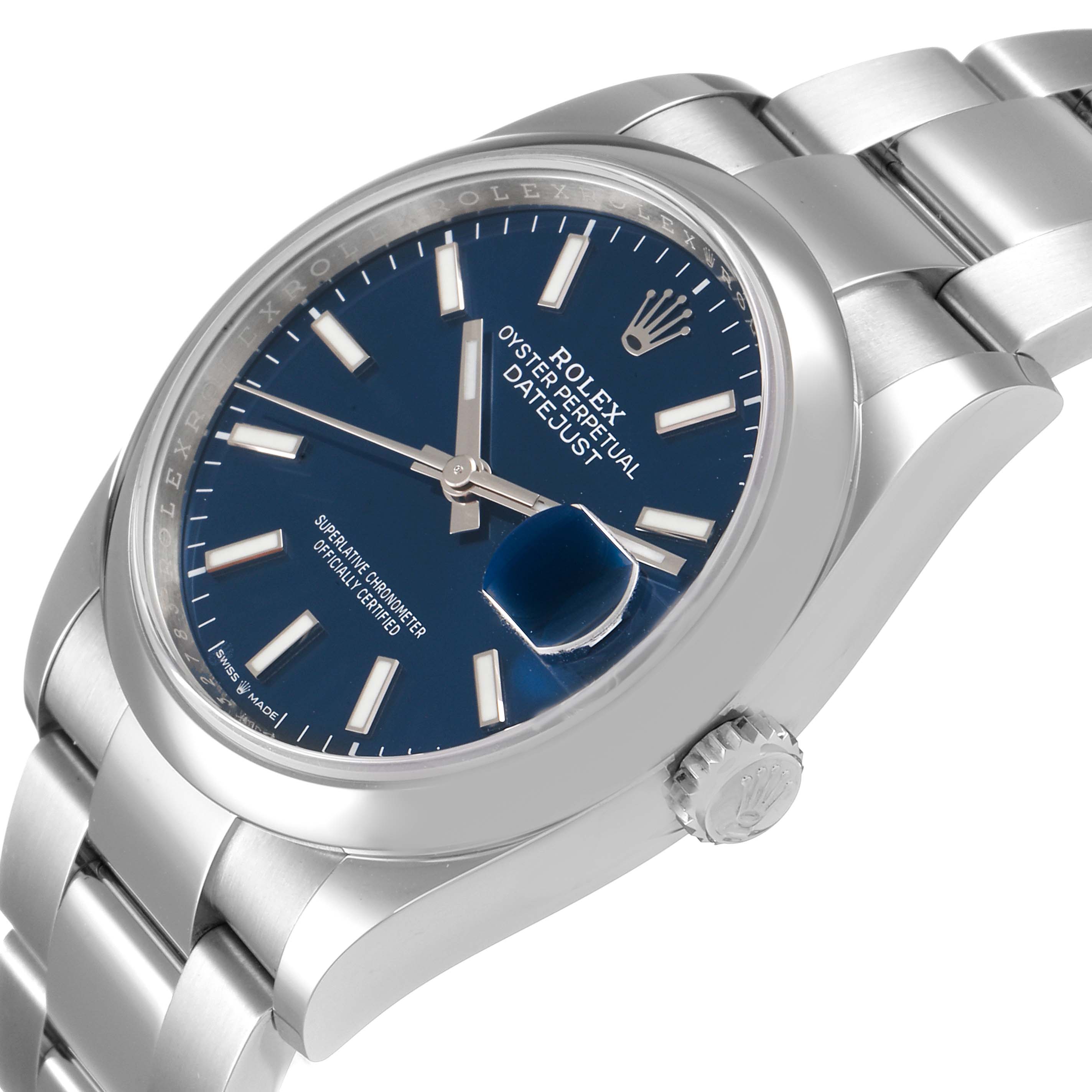 The image shows an angled close-up view of a Rolex Datejust 126200 Men
s Stainless Steel Blue Dial 126200 Men
s Stainless Steel Blue Dial watch, highlighting the dial, bezel, crown, and part of the bracelet.