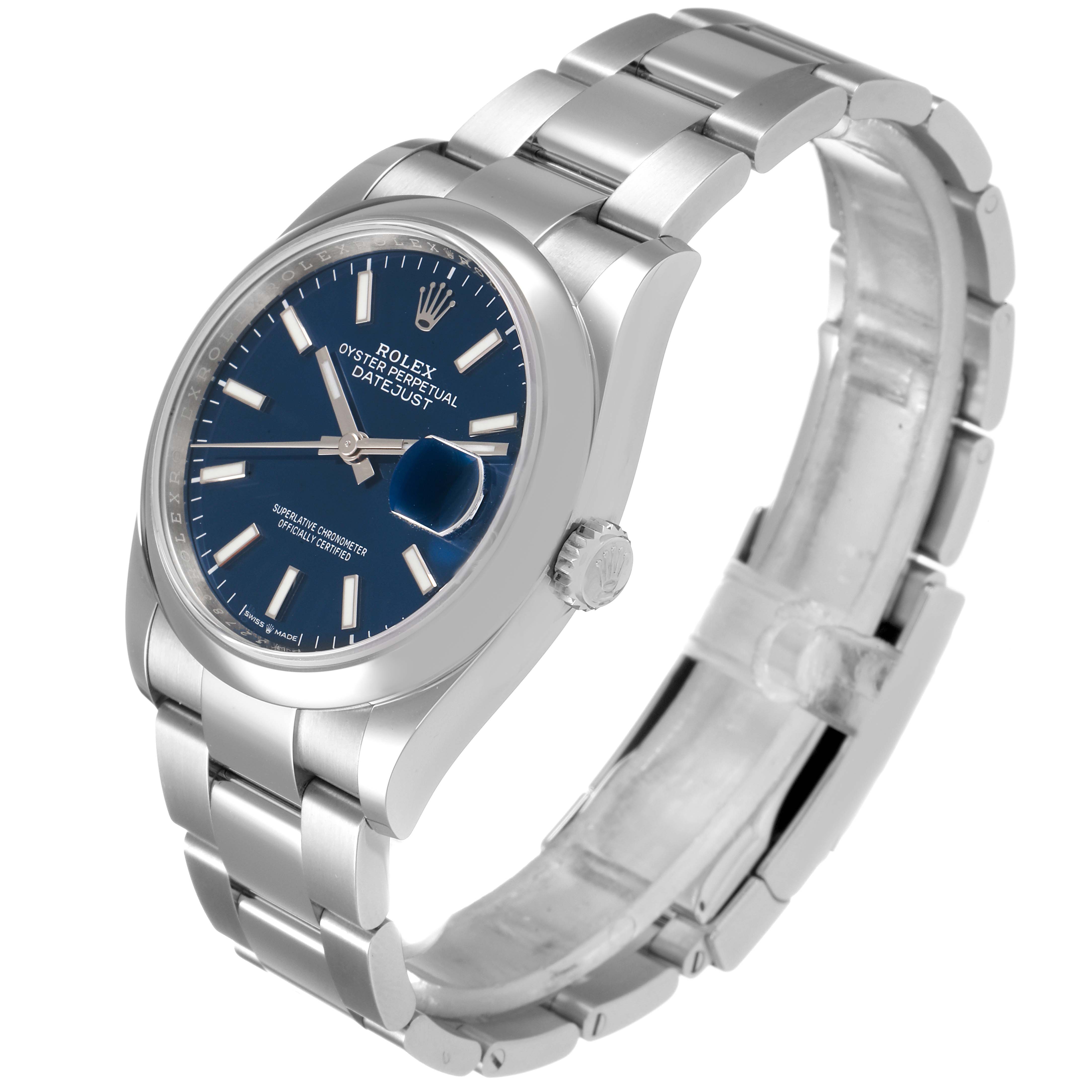 The image shows a Rolex Datejust 126200 Men
s Stainless Steel Blue Dial 126200 Men
s Stainless Steel Blue Dial watch at a slight angle, displaying its blue dial, silver bracelet, and crown.