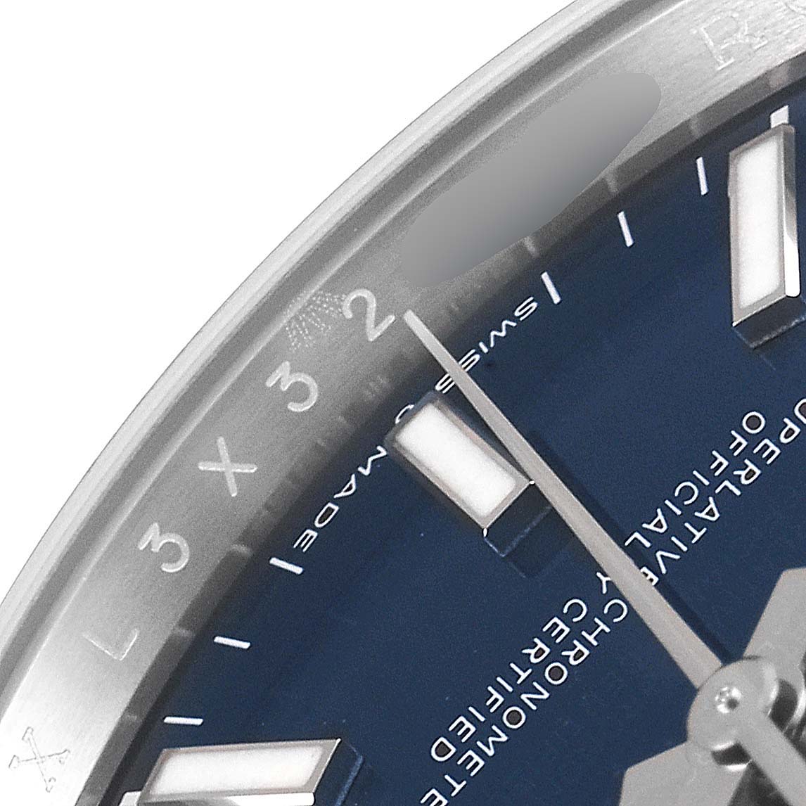 This image shows a close-up view of the dial on a Rolex Datejust 126200 Men
s Stainless Steel Blue Dial 126200 Men
s Stainless Steel Blue Dial, featuring the hands, markers, and part of the rehaut with serial numbers.
