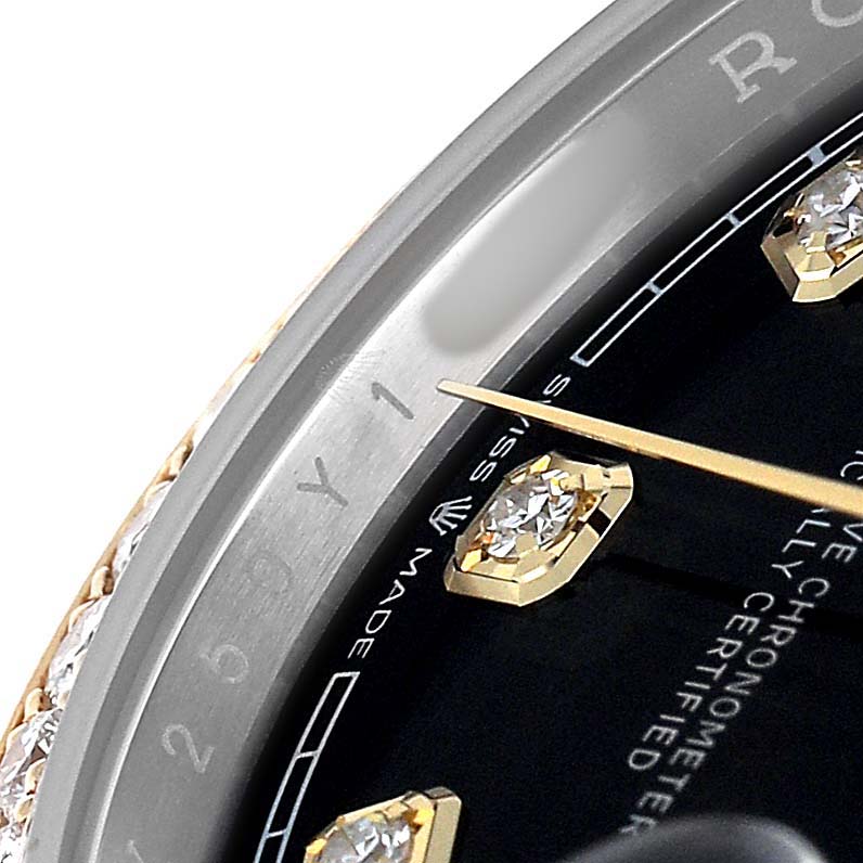 The image shows a close-up of the dial and bezel of a Rolex Datejust 126283 Men's Steel and Gold (two tone) Black Dial, highlighting diamond hour markers and a gold minute hand.