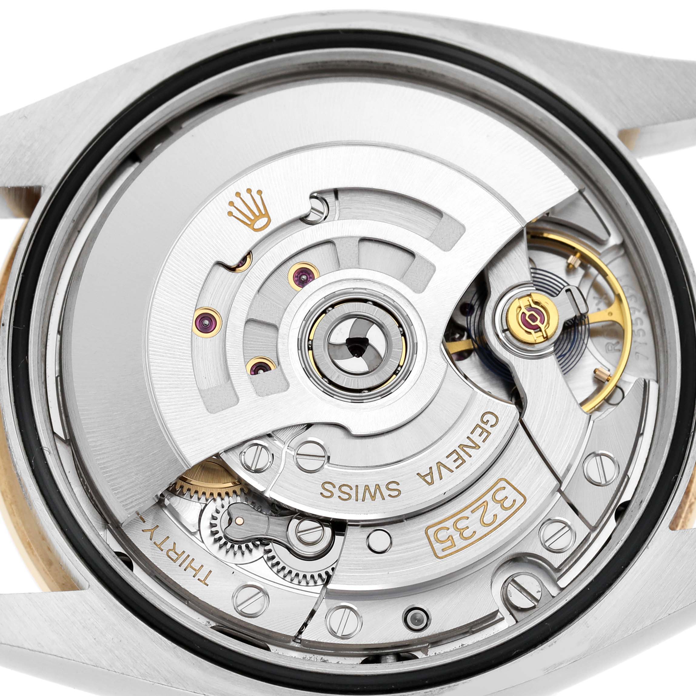 The image shows the back view of a Rolex Datejust 126283 Men's Steel and Gold (two tone) Black Dial, highlighting its intricate movement and rotor.