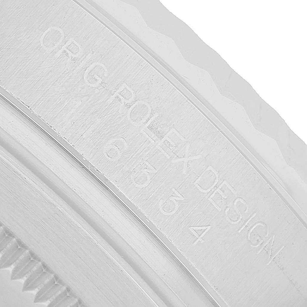 The image shows a close-up of the engraving on the side of the case of a Rolex Datejust 41 116334 Men's Stainless Steel Silver Dial watch.