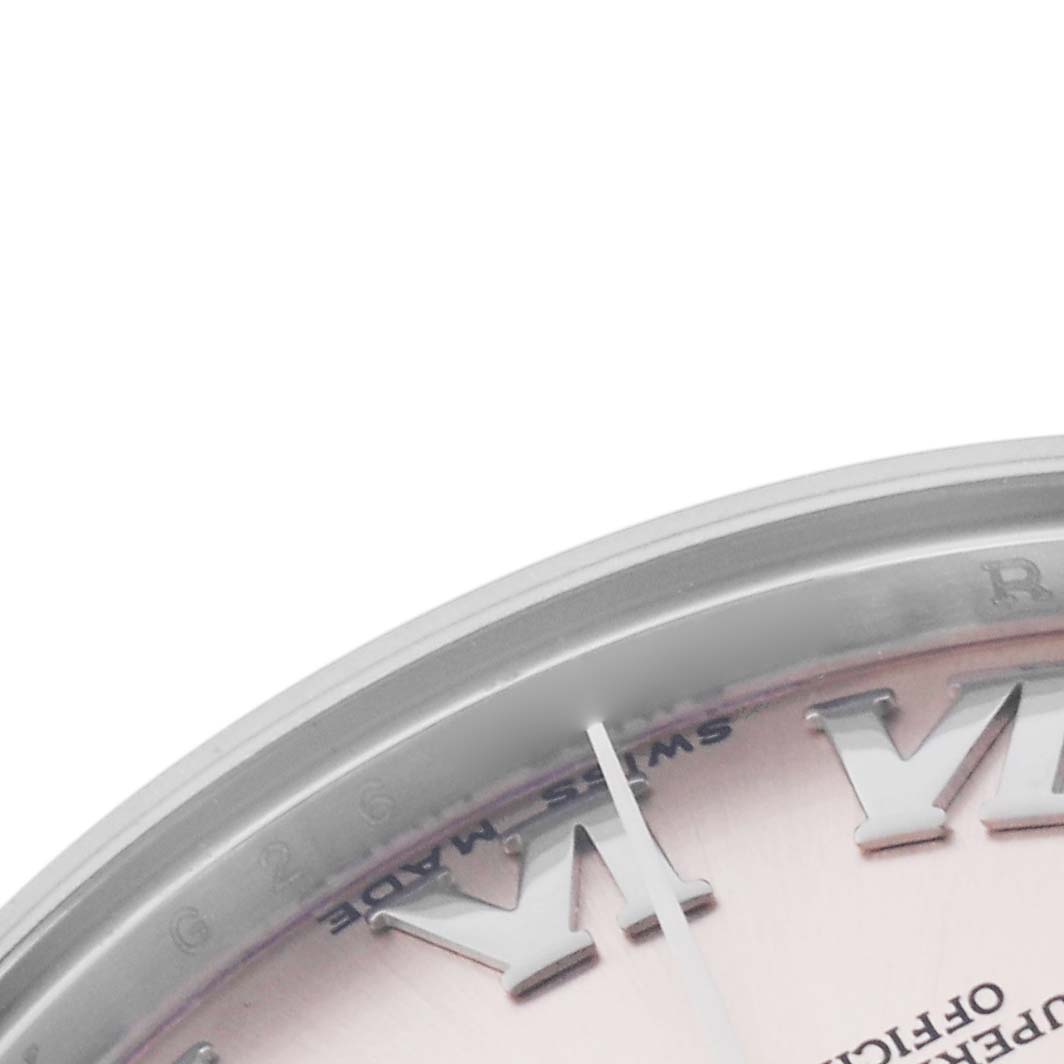The image shows a close-up of the Rolex Mid-Size 178240 Women's Stainless Steel Pink Dial 178240 Women's Stainless Steel Pink Dial watch's bezel and part of the dial with Roman numerals.