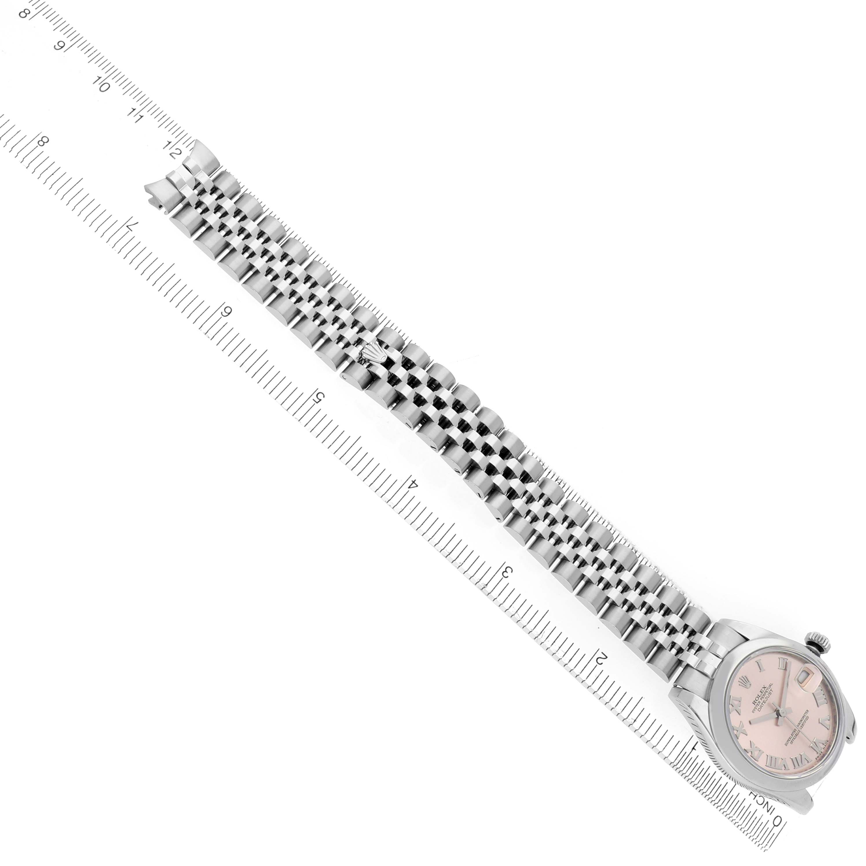 The Rolex Mid-Size 178240 Women's Stainless Steel Pink Dial 178240 Women's Stainless Steel Pink Dial watch is shown from an angled top view, displaying the dial and full bracelet alongside a ruler.