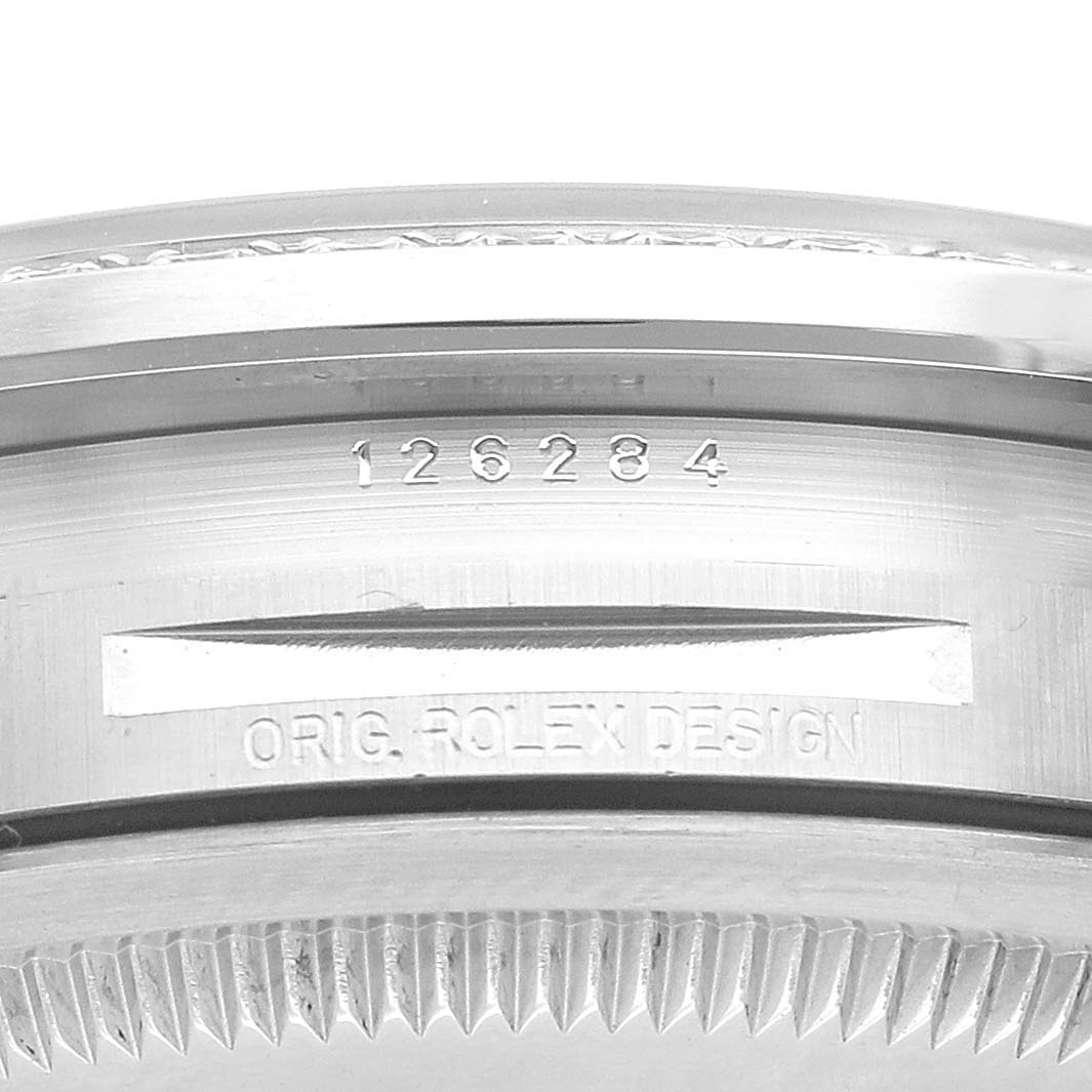 The image shows a close-up of the case side of a Rolex Datejust 126284 Men's Stainless Steel Silver Dial 126284 Men's Stainless Steel Silver Dial, featuring the engraved model number "126284" and "Orig. Rolex Design."